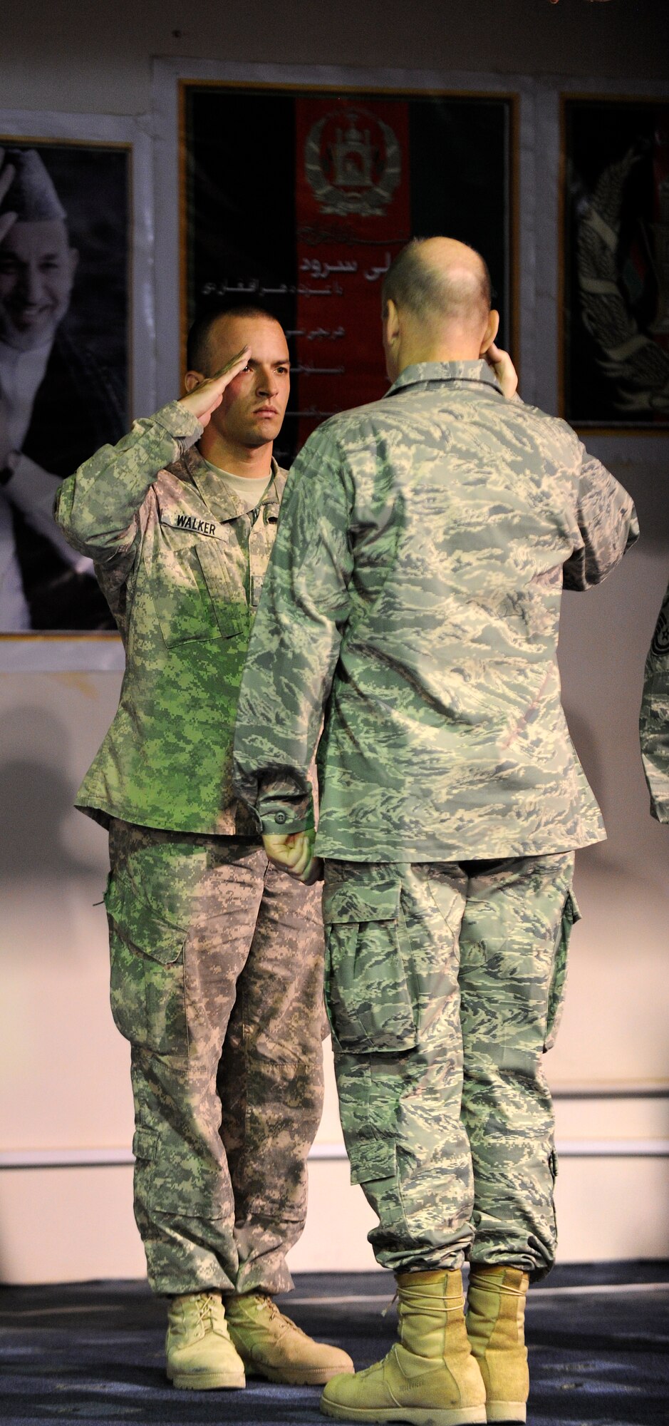 U.S. Navy Mass Communications Specialist Third Class Jared Walker Salutes U.S. Air Force Brig. Gen. David Allvin, Commanding General, NATO Air Training Command - Afghanistan at Kabul International Airport, Kabul, Afghanistan, August 13, 2011.  Walker received the Joint Commendation Medal with Valor for actions taken in the line of fire April 27, 2011.  (U.S. Air Force Photo by Staff Sergeant Matthew Smith)