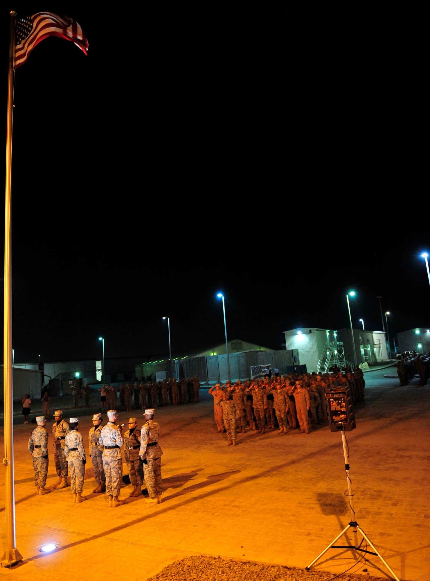 Members of the 380th Air Expeditionary Wing pay honor to the victims of the CH-47 Chinook helicopter crash that killed 38 U.S. and Afghan service members in Afghanistan during a taps ceremony at the deployed wing Aug. 11. (U.S. Air Force photo/Tech. Sgt. Patrick Mitchell)