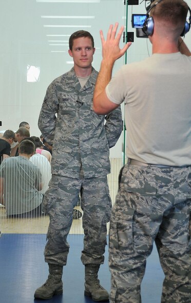 JBER, Alaska -- Airman 1st Class Ray Rush, a crew chief from the 176th Maintenaince Group, gives an interiew here July 16 to Air Guard videographer Tech. Sgt. James Michaels. The 176th Wing's student flight program was filmed for a National Guard Bureau project to enhance recruiting, career development and diversity. Rush recently moved on from the wing's student flight. 