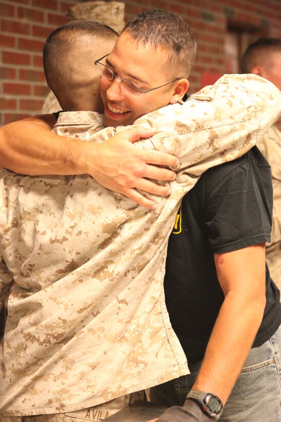 Sgt. Joshua A. Elliott, a combat engineer with 1st Platoon, Company C, 2nd Combat Engineer Battalion, 2nd Marine Division, hugs a fellow Marine from his platoon upon the platoon’s return from Afghanistan aboard Marine Corps Base Camp Lejeune, August 13, 2011. Elliott was injured during the seventh month deployment in which the platoon was attached to 2nd Battalion, 8th Marine Regiment, 2nd MarDiv.