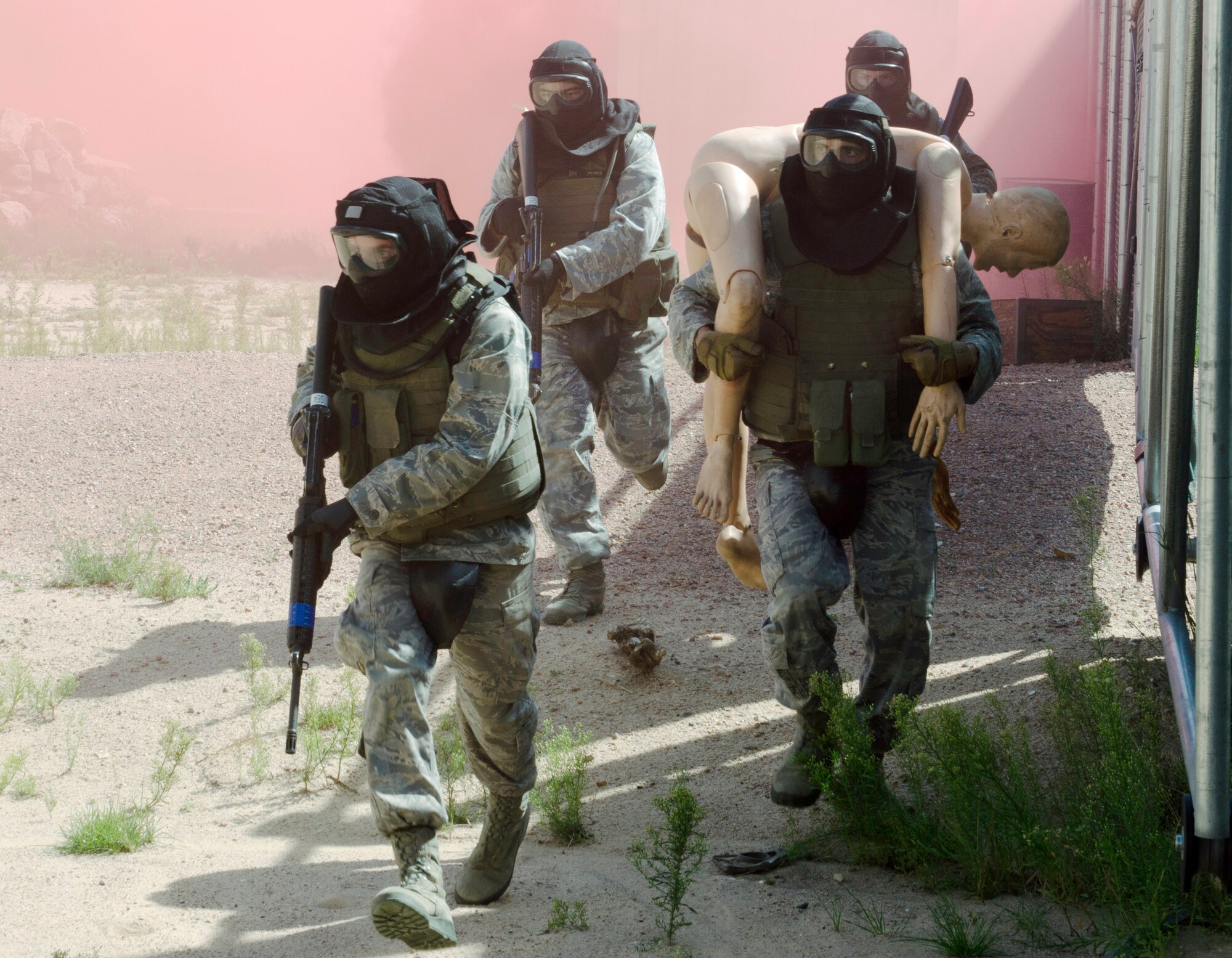 Cadet 3rd Class Jared Hafich carries a mannequin representing an injured pilot toward a safehouse as other cadets in his fire team provide cover during a training exercise in Jacks Valley's mobile operations in urban terrain training area Aug. 13, 2011. Hafich and the others, all members of the Air Force Academy's cadet combat shooting team, undertook the training as part of a commandant of cadets initiative called Polaris Warrior. Soldiers from Fort Carson's 10th Special Forces Group provided the training. Hafich is assigned to Cadet Squadron 28. (U.S. Air Force photo/Don Branum)