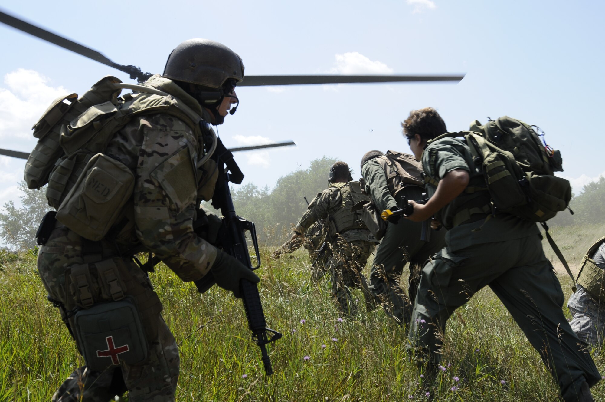 Master Sgt Michael McGann of the 107th Special Operations Weather Team from Selfridge Air National Guard Base provides security during a simulated rescue of three "downed" pilots during the Gray Wolverine exercises held at Combat Readiness Training Center Alpena, Mich., July 27, 2011. (USAF photo by TSgt David Kujawa)