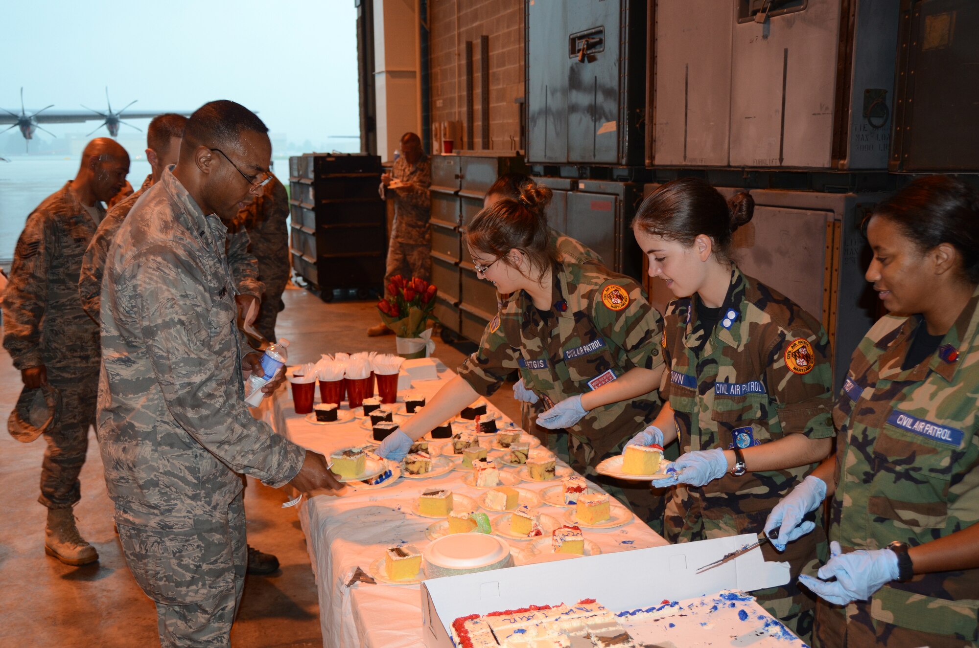 Members of the Maryland Wing Civil Air Patrol serve refreshments to members of the 175th Wing Maryland Air National Guard after the arrival ceremony for the C-27J Spartan.  On August 13, 2011, the 175th Wing held an arrival ceremony for the C-27J Spartan at Warfield Air National Guard Base, Baltimore, MD.  The ceremony marked a transition from the C-130J Hercules to the C-27J Spartan.  (U.S. Air Force photo by Technical Sgt. Christopher Schepers/RELEASED)