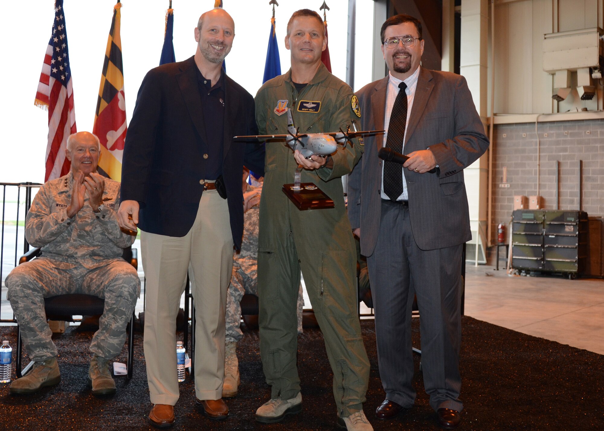 Mr. Jim Meltsner from Alenia North America and Mr. Kenneth McAlpin from L-3 Communications present Col. Scott L. Kelly, commander of the 175th Wing, Air National Guard, a model of the new C-27J Spartan during an arrival ceremony for the aircraft on August 13, 2011 at Warfield Air National Guard Base, Baltimore, MD.  The arrival of the C-27J Spartan marks the transition from the C-130J which had been with the Maryland Air Guard since 1999.   (U.S. Air Force photo by Staff Sgt. Benjamin Hughes/RELEASED)