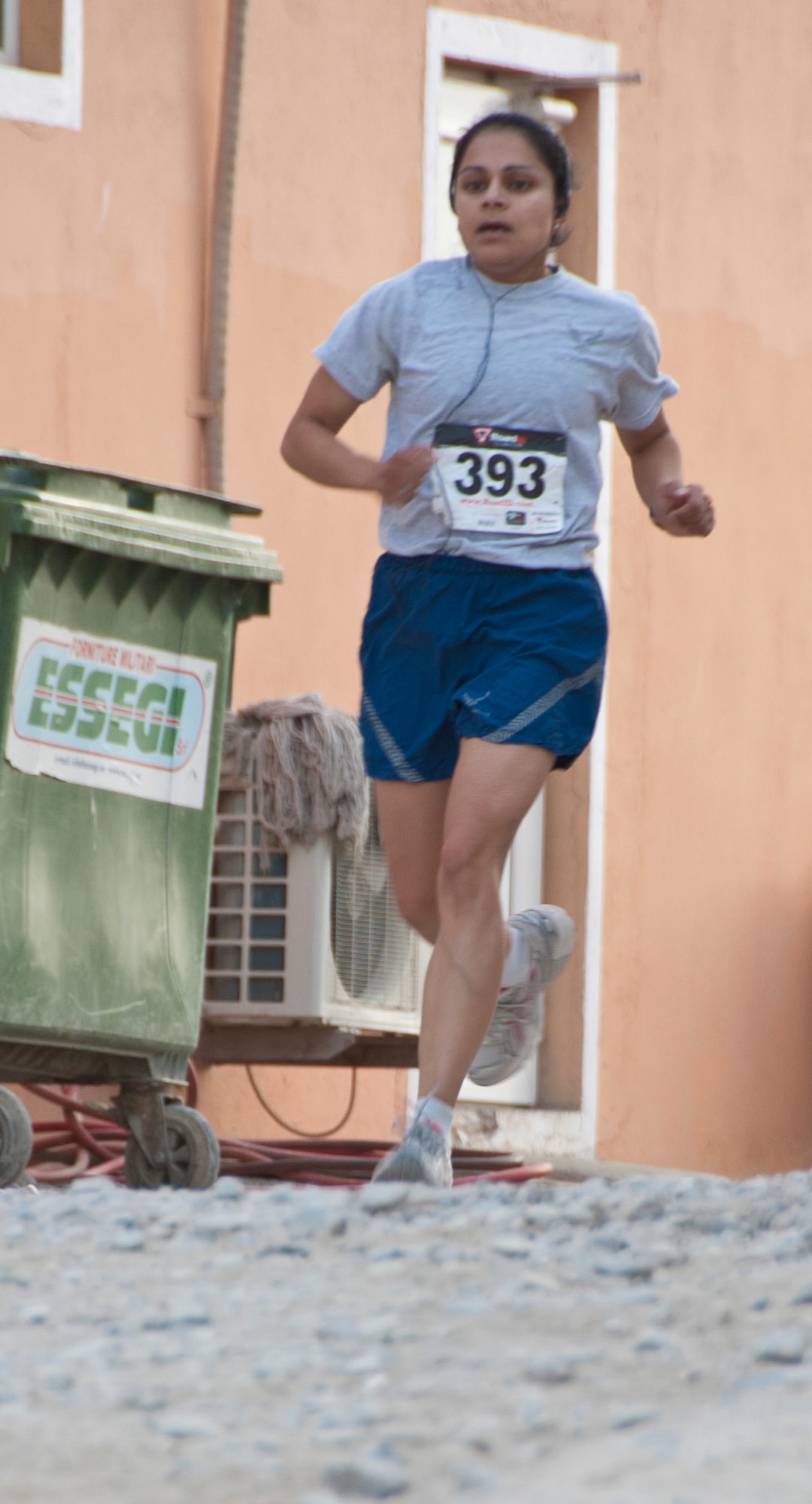 KANDAHAR AIRFIELD, Afghanistan – Air Force Maj. Aarti Puri, Defense Contract Management Agency, runs to the finish line during the 2nd Annual U.S. Navy “Run with the Chiefs” 5K Aug. 13, 2011. Puri was the top Air Force finisher and placed second in the female category with a time of 22:05. (U.S. Air Force photo by Senior Airman David Carbajal/Released)