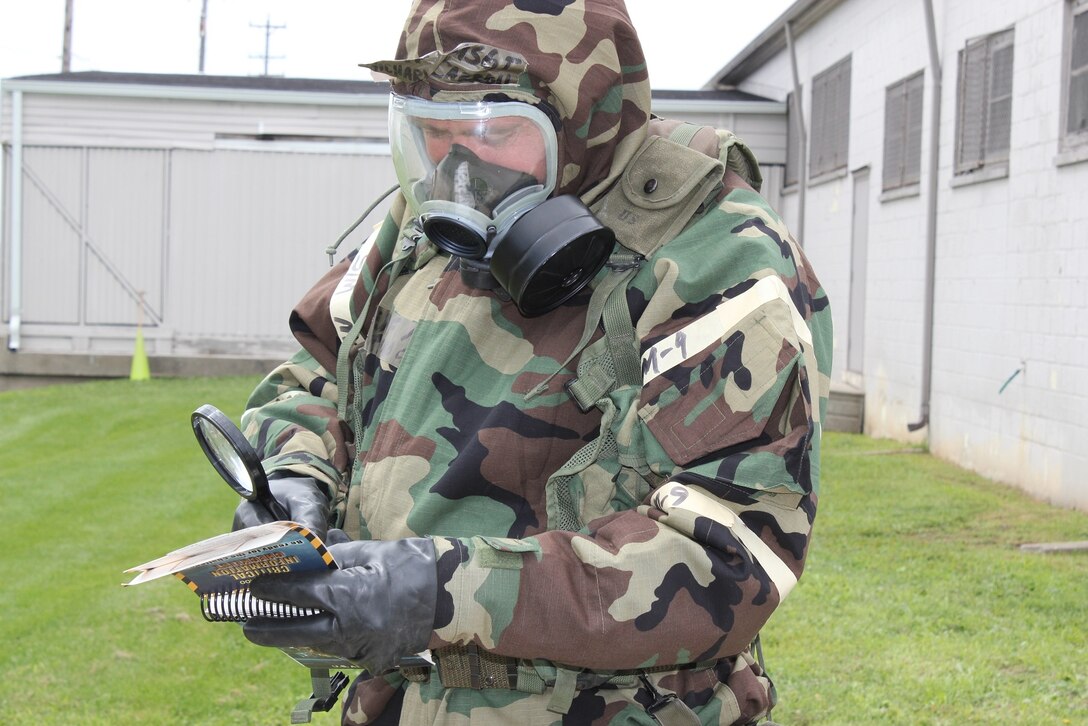 Airmen completely donned MOPP gear and practiced PAR Team training during Survival Skills training held at Selfridge Air National Guard Base on August 13.  During the exercise, the airmen were taught how to identify and mark unexploded ordnance, and use the Airman's Pamphlet 10-100. The were also shown how to identify contamination on liquid detection points using a magnifying glass. (USAF photo by Capt. Penny Carroll)