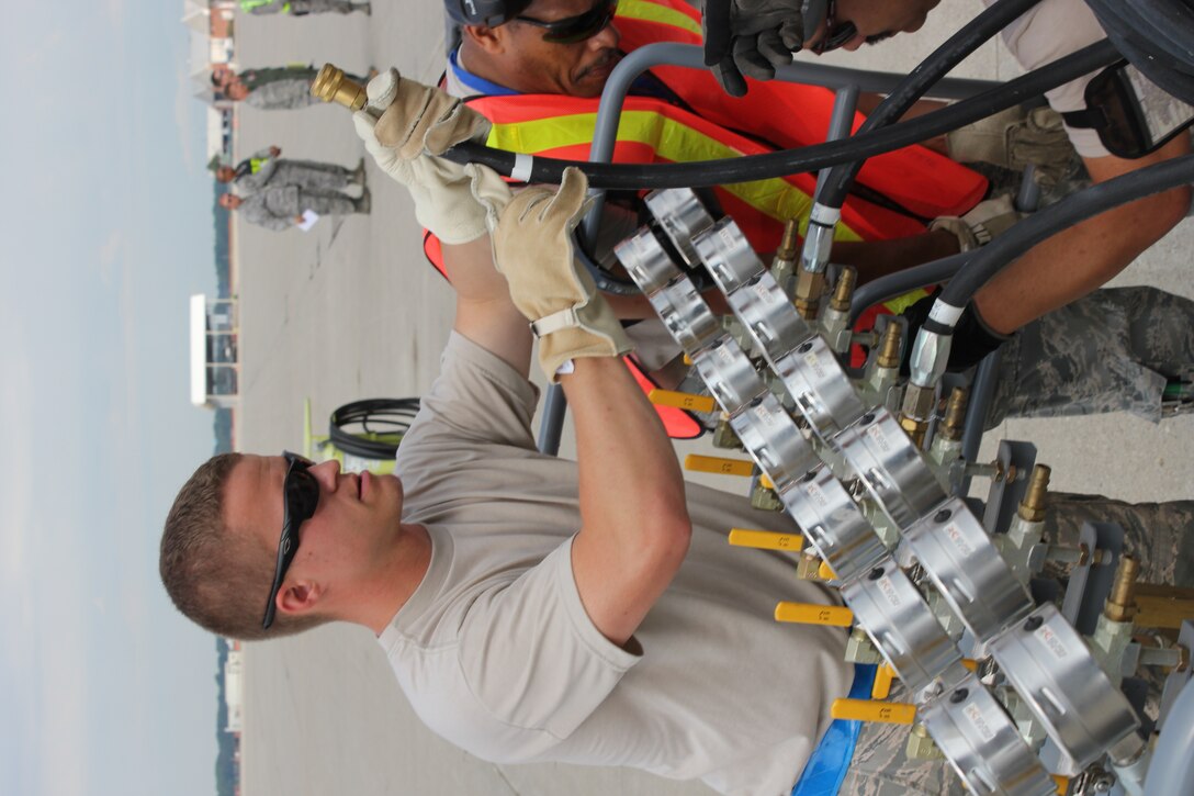 TSgt. Tim Kelly, 191st Maintenance Squadron, prepares to operates an air pressure regulator during an exercise at Selfridge Air National Guard Base, Mich., Aug. 13, 2011. The 191st MXS performed an exercise in which they simulated a KC-135 Stratotanker had damaged nose gear and a crane was needed to move the aircraft to a safe location for repair. The air system was used to fill a series of bladders that could cushion the tail of aircraft while the nose of the aircraft was lifted by a crane. (USAF photo by TSgt. Dan Heaton)