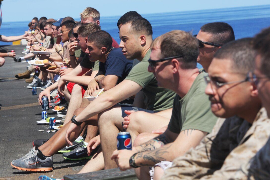 Marines and Sailors aboard USS Mesa Verde (LPD 19) eat and drink sodas on the flight deck during a Steel Beach, Aug. 14, 2011. Steel Beach’s are held to raise morale and unit camaraderie. Marines and sailors of the 22nd MEU are currently deployed with Amphibious Squadron 6 aboard the USS Bataan Amphibious Ready Group and will continue to train and improve the MEU’s ability to operate as a cohesive and effective Marine Air Ground Task Force.  The 22nd MEU is a multi-mission, capable force, comprised of an Aviation Combat Element, Marine Medium Tilt Rotor Squadron 263 (Reinforced); a Logistics Combat Element, Combat Logistics Battalion 22; a Ground Combat Element, Battalion Landing Team, 2nd Battalion, 2nd Marine Regiment; and its Command Element.