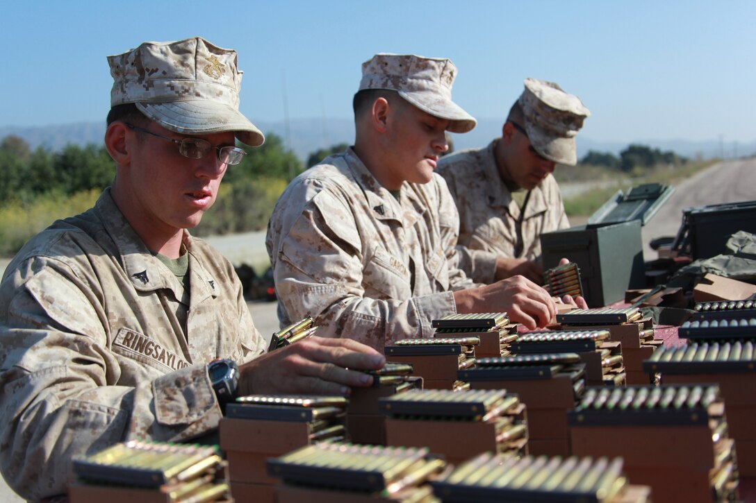 Marines with Combat Logistics Battalion 11 count ammunition here Aug. 14. The battalion, which provides logisitics and services to the 11th Marine Expeditionary Unit, participated in combat marksmanship training as part of its pre-deployment training.