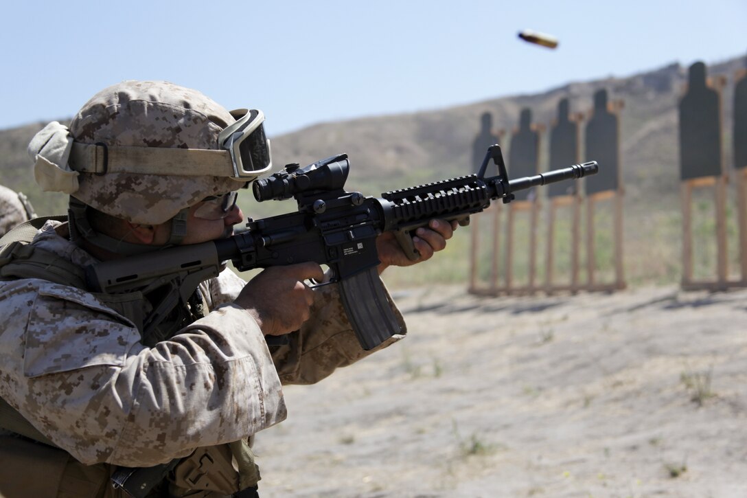 Cpl. Andrew J. Martinez fires his rifle here Aug. 14. Martinez, 27, is the armory chief for Combat Logistics Battalion 11, 11th Marine Expeditionary Unit, and is an El Centro, Calif., native. The battalion participated in combat marksmanship training as part of their pre-deployment training plan.