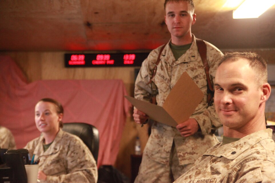 From left to right, 1st Lt. Martha  A. Hiett, 1st Lt. Joel R. Searls and Lt. Col. Robert Cooper work in the  Tactical Air Command Center for the 2nd Marine Aircraft Wing (Forward) in Camp Leatherneck, Afghanistan. The command center is the mechanism from which aviation elements are managed in the southwestern regional command of NATO's International Security Assistance Force. Hiett is a native of Willow Springs, Mo. and a senior representative for the Marine Air Command and Control System for the command center. Searls is a close battle coordinator for the command center and a native of Pickerington, Ohio. Cooper is a senior watch officer for the command center and native of Tulsa, Okla.