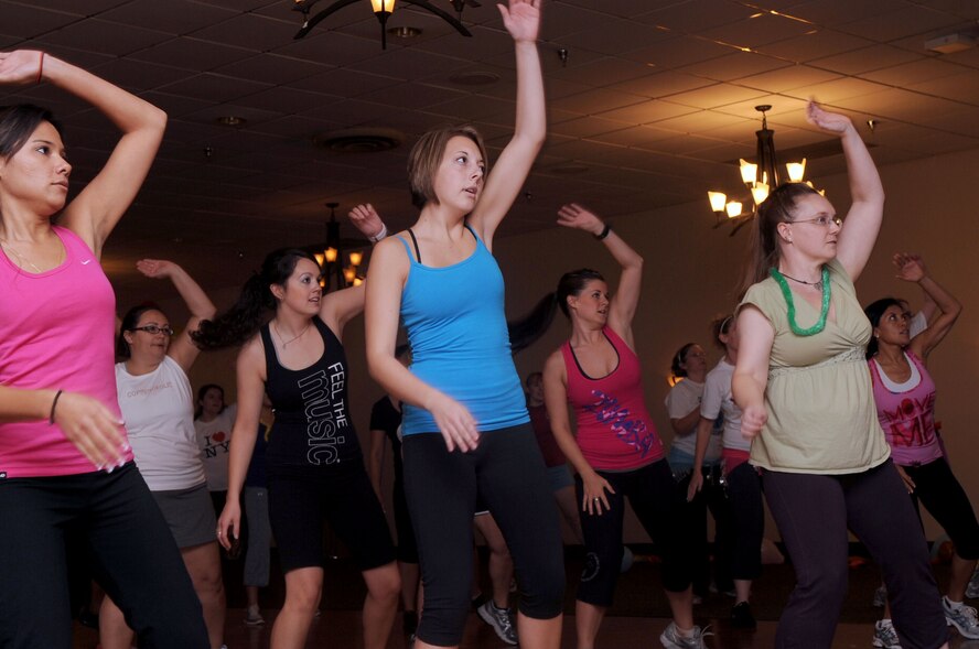 Participants of the Zumbathon fundraiser move to the beat at the Stripes Club on Barksdale Air Force Base, La., Aug. 11. The fundraiser was held to raise money for Minot Air Force Base, N.D., Airmen and families affected by the recent floods. More than 40 Airmen, civilians and spouses attended the event and raised a total of $1,000 for the displaced families. (U.S. Air Force photo/Senior Airman La'Shanette V. Garrett) (RELEASED)