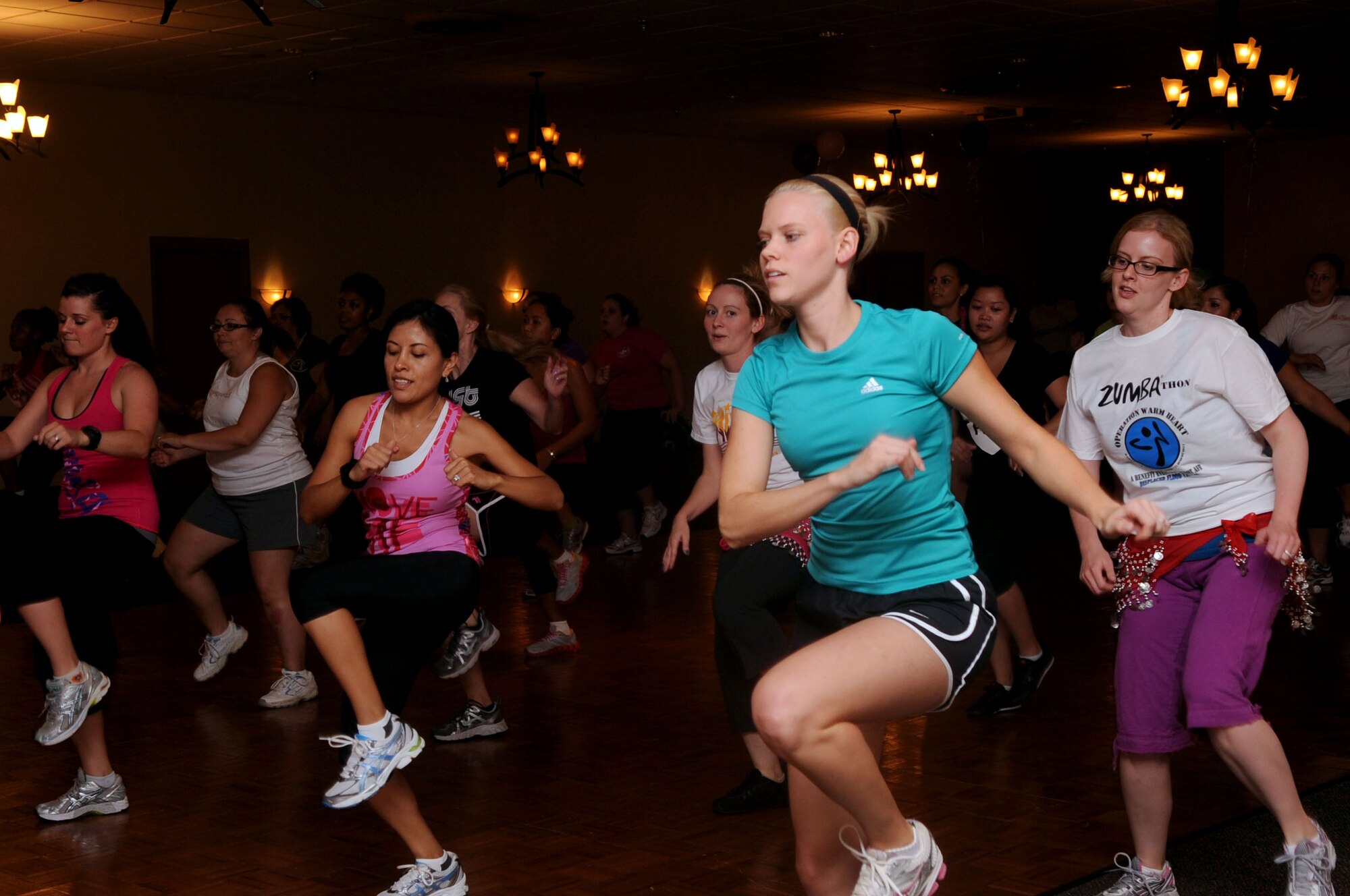 Participants of the Zumbathon fundraiser move to the beat at the Stripes Club on Barksdale Air Force Base, La., Aug. 11. The fundraiser was held to raise money for Minot Air Force Base, N.D., Airmen and families affected by the recent floods. More than 40 Airmen, civilians and spouses attended the event and raised a total of $1,000 for the displaced families. (U.S. Air Force photo/Senior Airman La'Shanette V. Garrett) (RELEASED)
