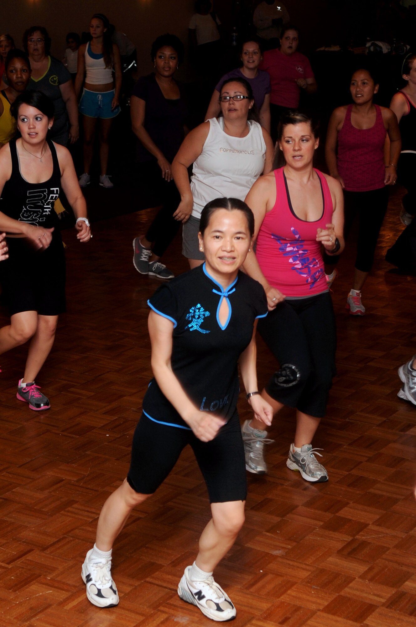 Participants of the Zumbathon fundraiser move to the beat at the Stripes Club on Barksdale Air Force Base, La., Aug. 11. The fundraiser was held to raise money for Minot Air Force Base, N.D., Airmen and families affected by the recent floods. More than 40 Airmen, civilians and spouses attended the event and raised a total of $1,000 for the displaced families. (U.S. Air Force photo/Senior Airman La'Shanette V. Garrett) (RELEASED)