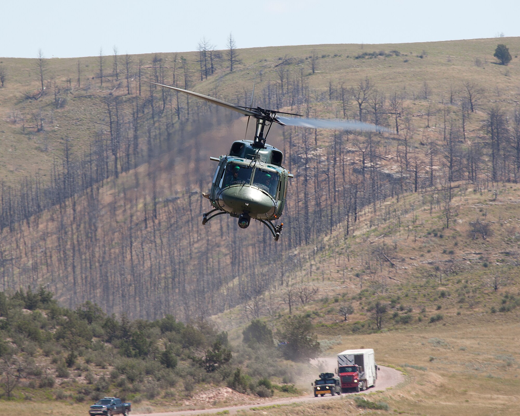 A UH-1N fly’s overhead during a demonstration as part of Crimson Rider August 10, 2011. Crimson Rider is a security demonstration designed to exchange best practices for security, safety, and control of nuclear weapons during transport. (U.S. Air Force photo by Matt Bilden)