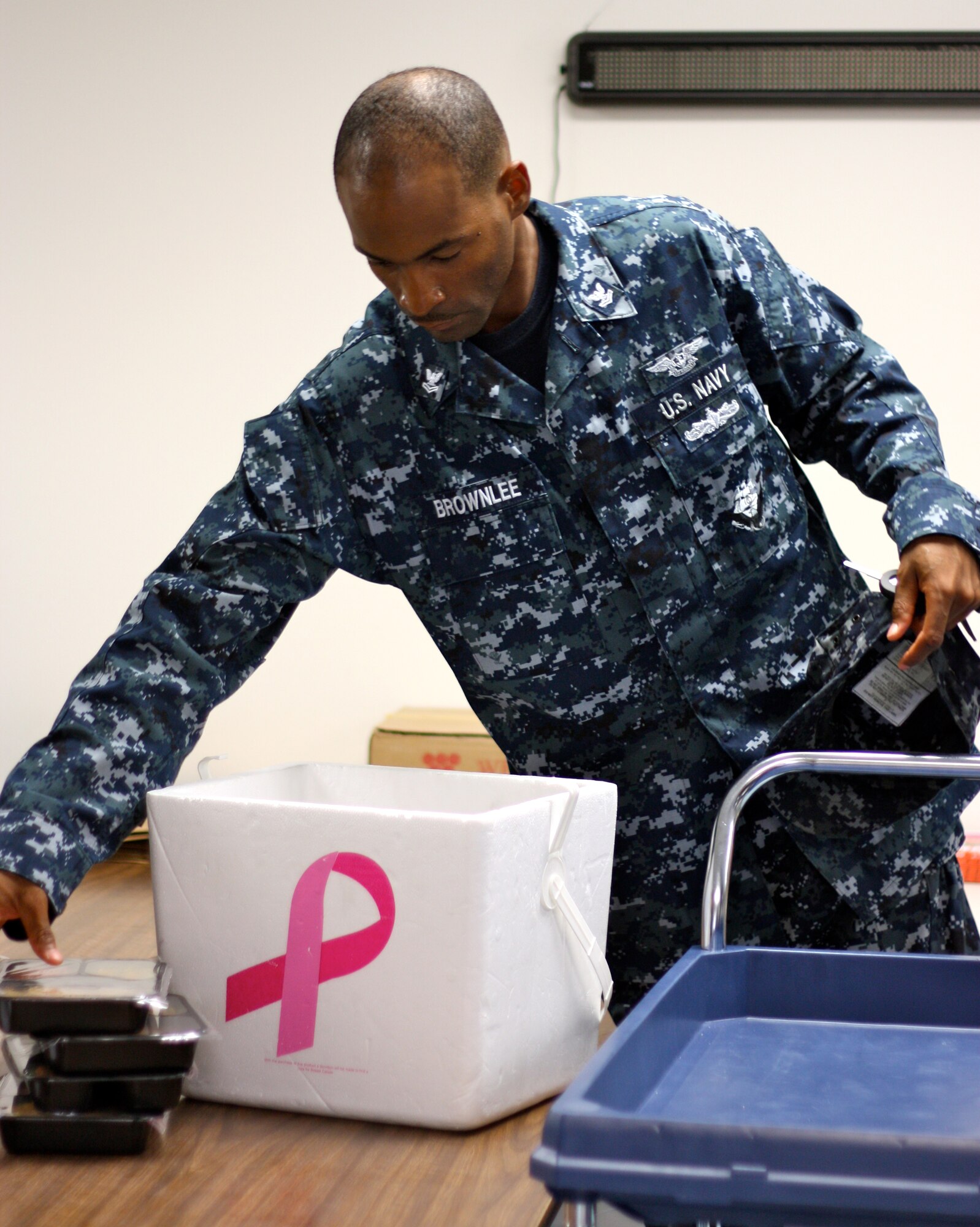 SAN ANGELO, Texas -- Navy Petty Officer 2nd Class David Brownlee packs meals that he and his team will deliver to the homes of those participating in the Meals for the Elderly program Aug. 12. (Courtesy photo/Whitney Haskell)