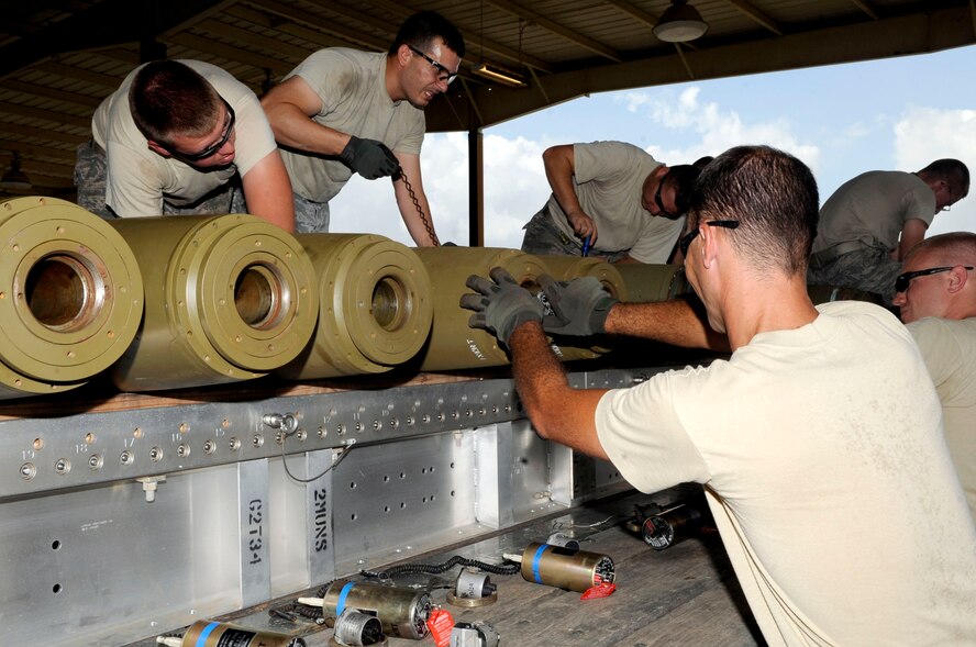Members of the 2nd Munitions Squadron Global Strike Challenge team race against the clock to simulate arming Mark-82 bombs on Barksdale Air Force Base, La., Aug. 11 in preparation for the upcoming Air Force Global Strike Challenge competition. During the Global Strike Challenge, Airmen from operations, maintenance and security forces teams from bomber and missile wings throughout Air Force Global Strike Command will compete to be named best-of-the-best. (U.S. Air Force photo/Staff Sgt. Terri Barriere) (RELEASED)