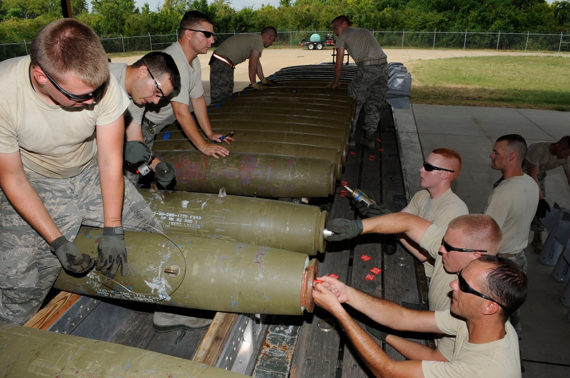 Members of the 2nd Munitions Squadron Global Strike Challenge team race against the clock to simulate arming Mark-82 bombs on Barksdale Air Force Base, La., Aug. 11, in preparation for the upcoming Air Force Global Strike Challenge competition. The Mark-82 is an unguided, low-drag general-purpose bomb. (U.S. Air Force photo/Staff Sgt. Terri Barriere) (RELEASED)