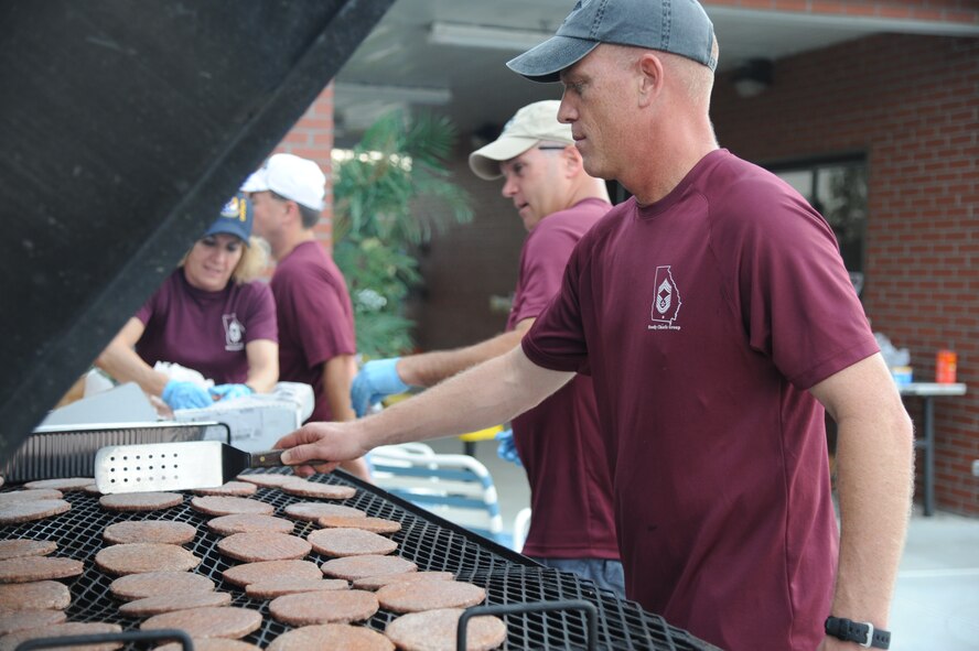 U.S. Air Force Chief Master Sgt. Frank Batten, 23rd Wing command chief, grills and flips burgers for Airmen Appreciation Night at Moody Air Force Base, Ga., Aug. 12, 2011. Batten was one of five chief master sergeants who volunteered during the event to show their appreciation for the Airman tier. (U.S. Air Force photo by Airman 1st Class Paul Francis/Released)