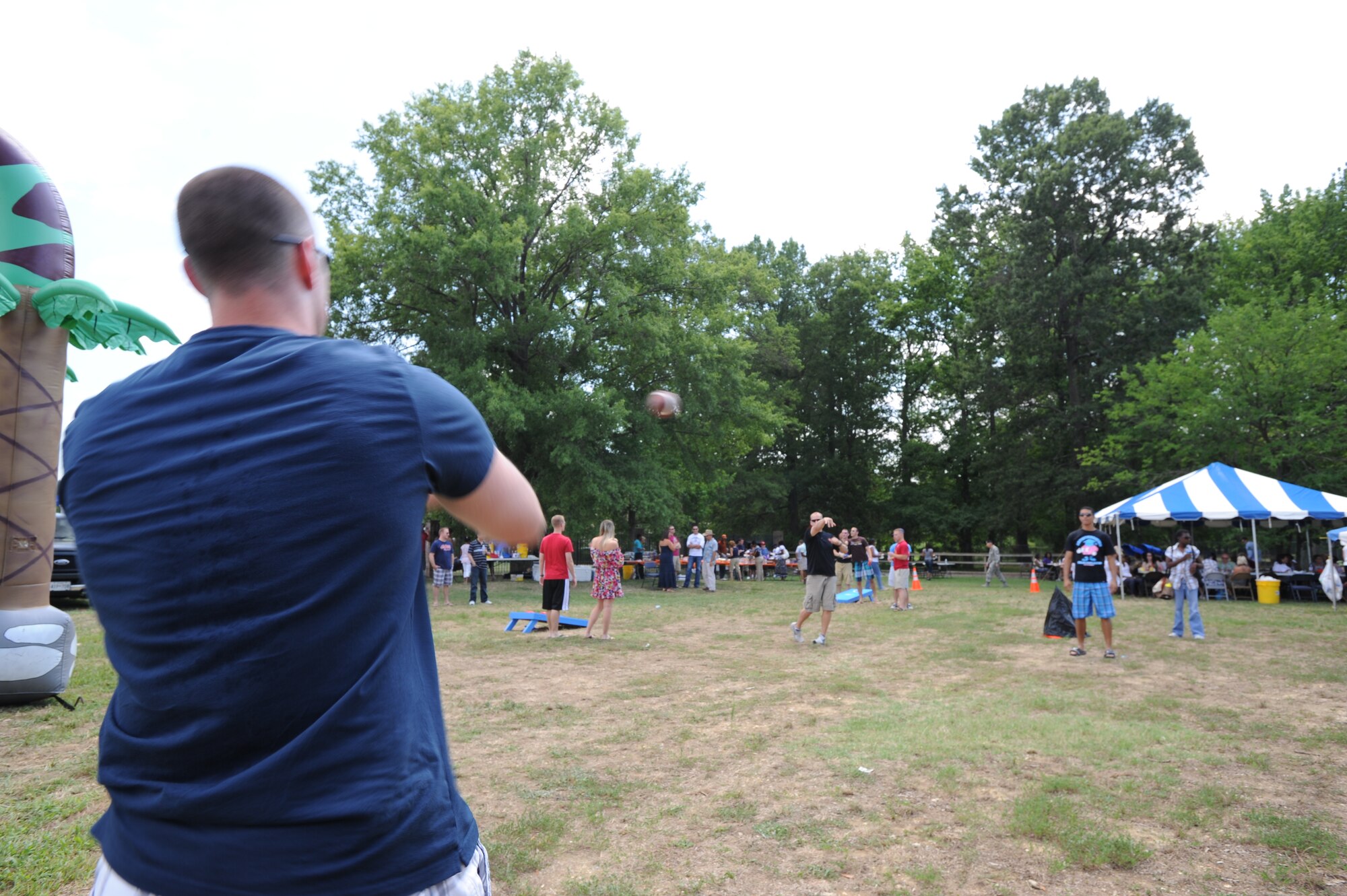 Airman 1st Class Matt Little, Air Force District of Washington contract specialist, receives the football during the AFDW family summer picnic on Joint Base Andrews, Md. Aug. 12. There were many activities for everyone to enjoy, including football, corn hole, relay events, and a bounce house for the children. (U.S. Air Force photo by Staff Sgt. Christopher Ruano)