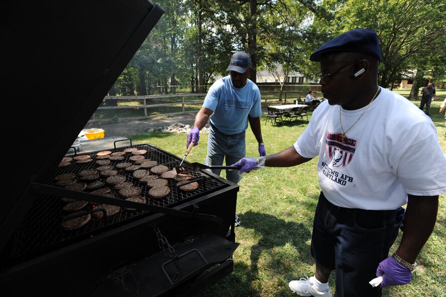 Air Force District of Washington members grill hamburgers for the AFDW Family Day celebration on Joint Base Andrews, Md. Aug. 12. The event brought AFDW families together to celebrate and unwind. (U.S. Air Force photo by Staff Sgt. Christopher Ruano)