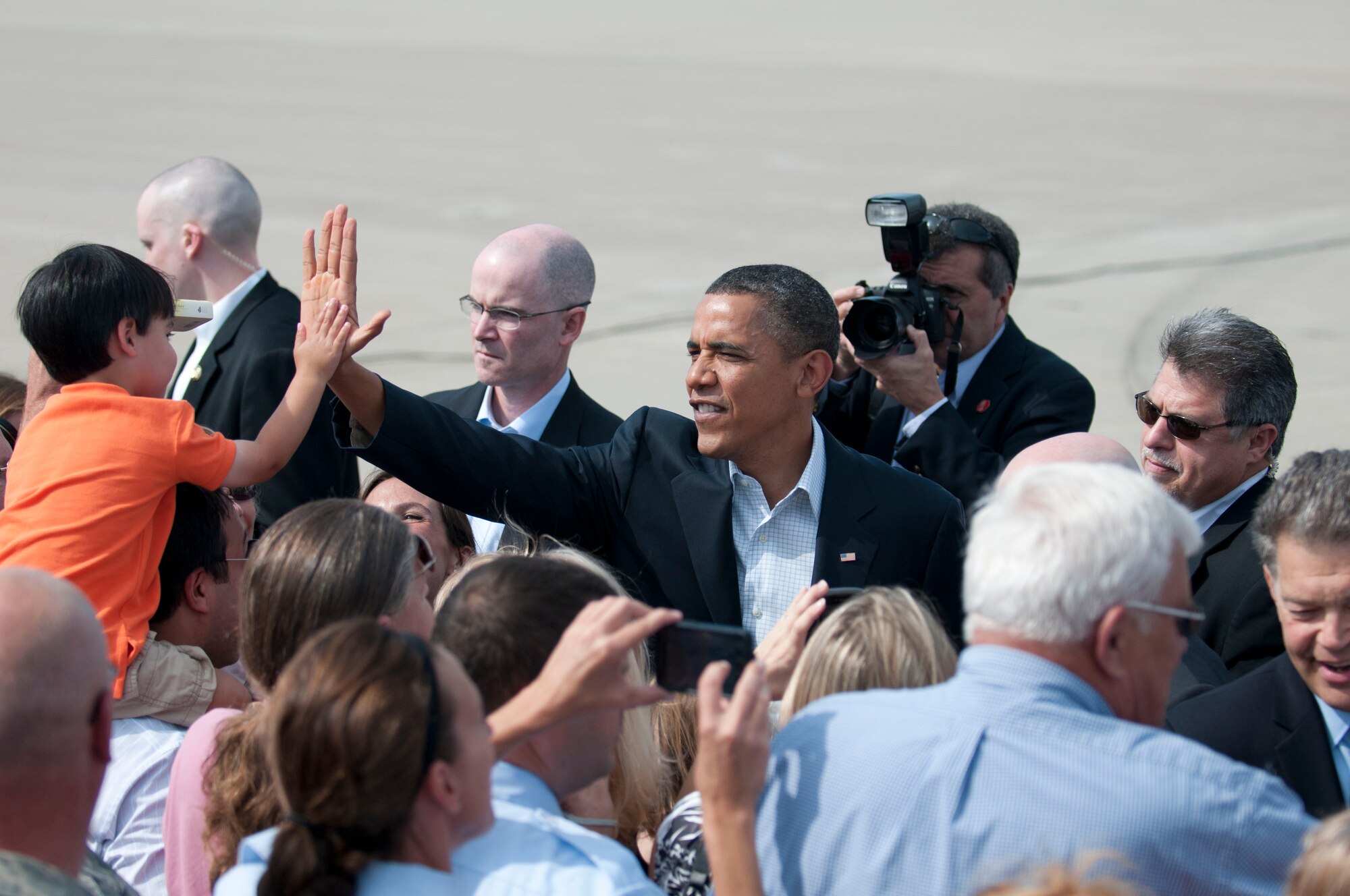 MINNEAPOLIS/ST. PAUL INTERNATIONAL AIRPORT –President Barrack Obama gives a high-five to a child after arriving here today as he greeted the crowd that consisted of members of the 133rd Airlift Wing and invited guests .  Obama arrived here to start a three-day bus tour through Minn., Iowa, and Ill. (USAF official photo by Senior Airman Jonathan Young)