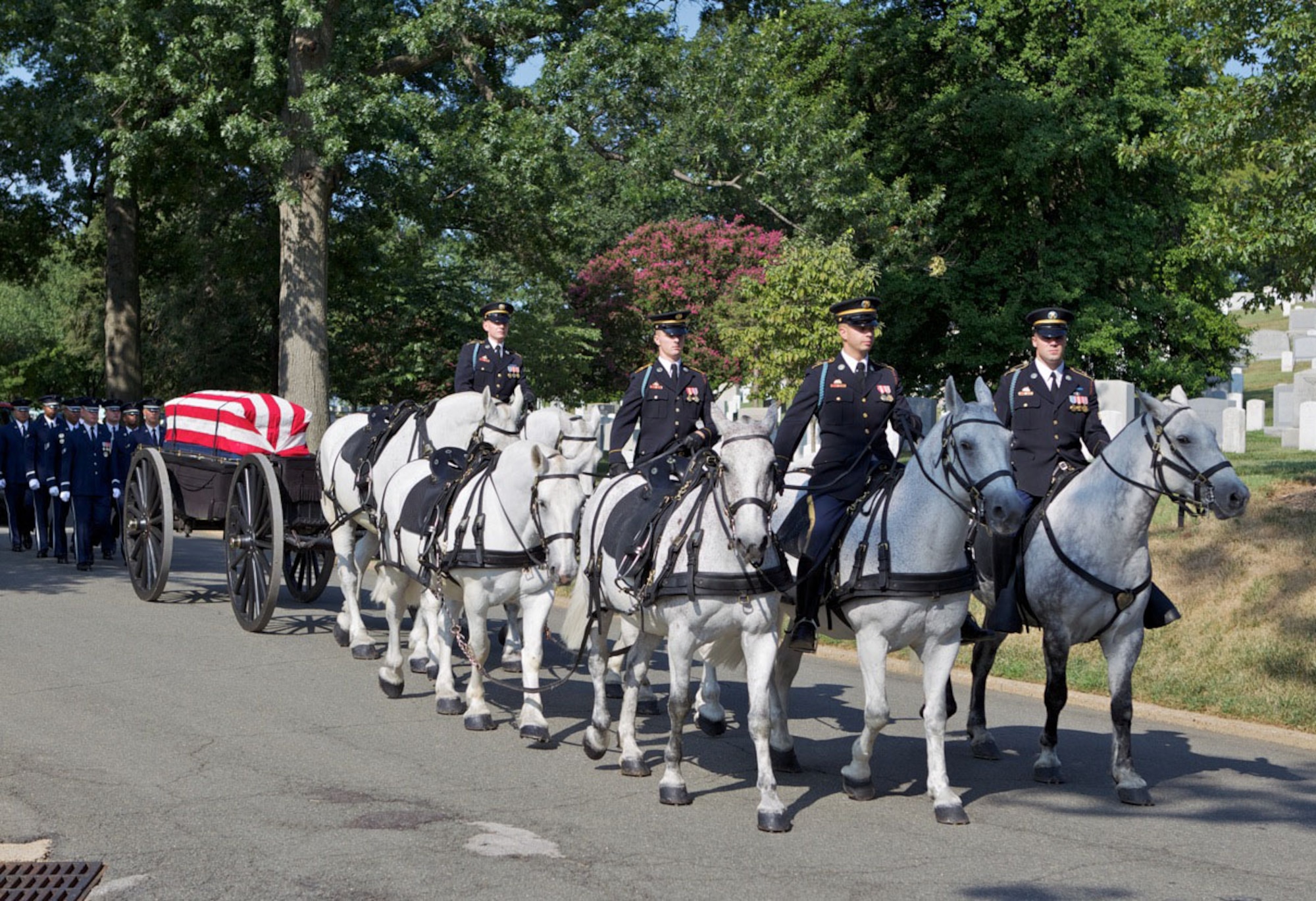Soldiers from the U.S. Army’s Old Guard lead the horse-drawn caisson Aug. 12, 2011, carrying the casket of retired Col. John Carey to his final resting place in Arlington National Cemetery.  Following the caisson were members of the Air Force Honor Guard and Ceremonial Brass Band, and his family, friends and fellow Airmen who came to pay their final respects.  (Courtesy photo/Jerry Hughes)