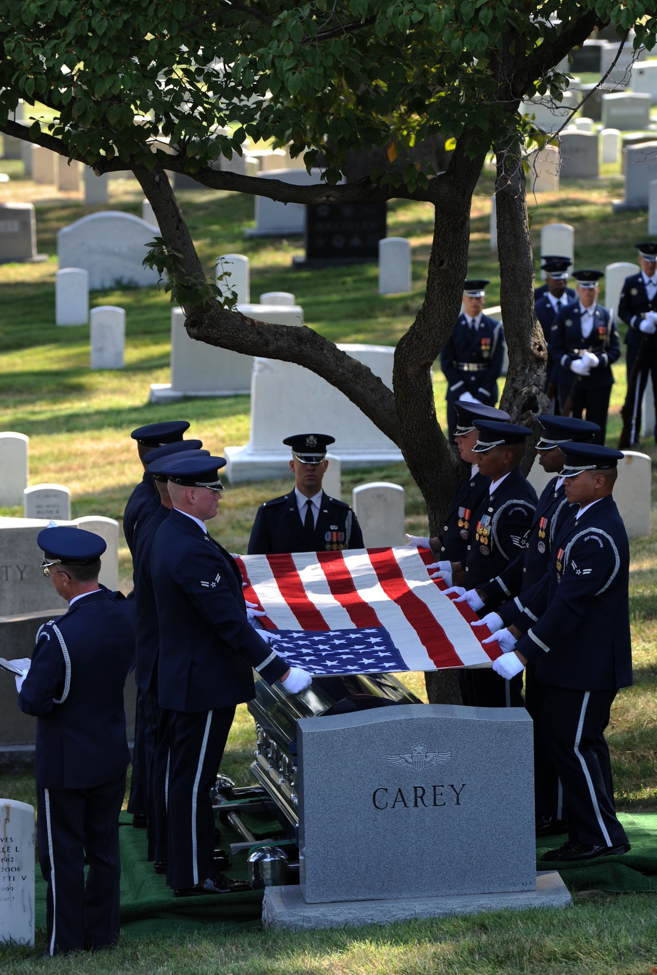 Members of the Air Force Honor Guard prepare to fold the flag during the funeral service at Arlington National Cemetery for retired Col. John Carey Aug. 12, 2011. As the ceremonial flag was folded for the last time, the Air Force chaplain presiding over the ceremony quoted the inscription on the John Paul Jones Memorial: “In life he honored the flag. In death the flag shall honor him.” (U.S. Air Force photo/Staff Sgt. Tiffany Trojca)