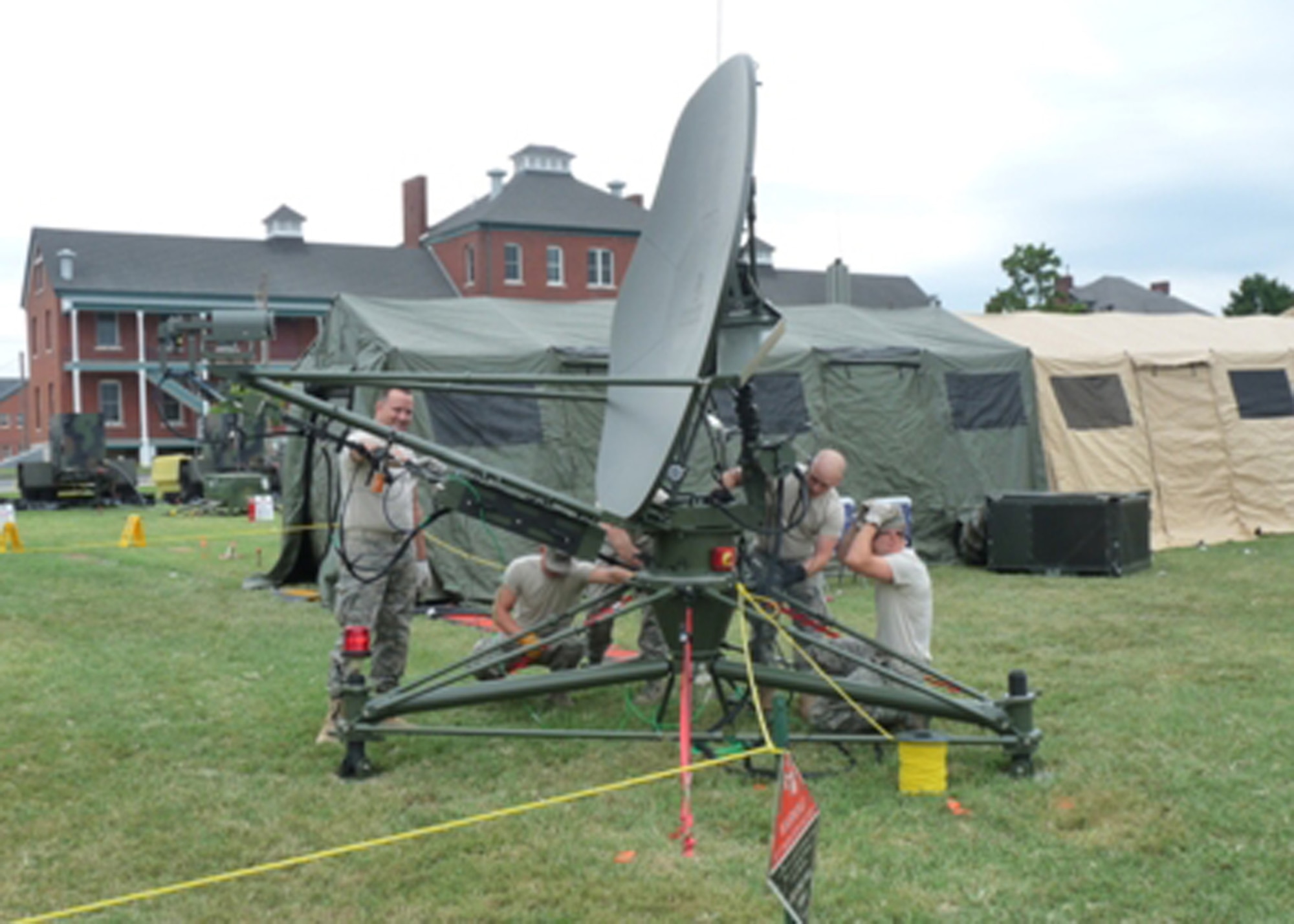 Airmen of the 239th Combat Communications Squadron, Missouri Air National Guard, adjust a satellite antenna at their field communications station at Jefferson Barracks, Missouri. (Photo by Bill Phelan) 