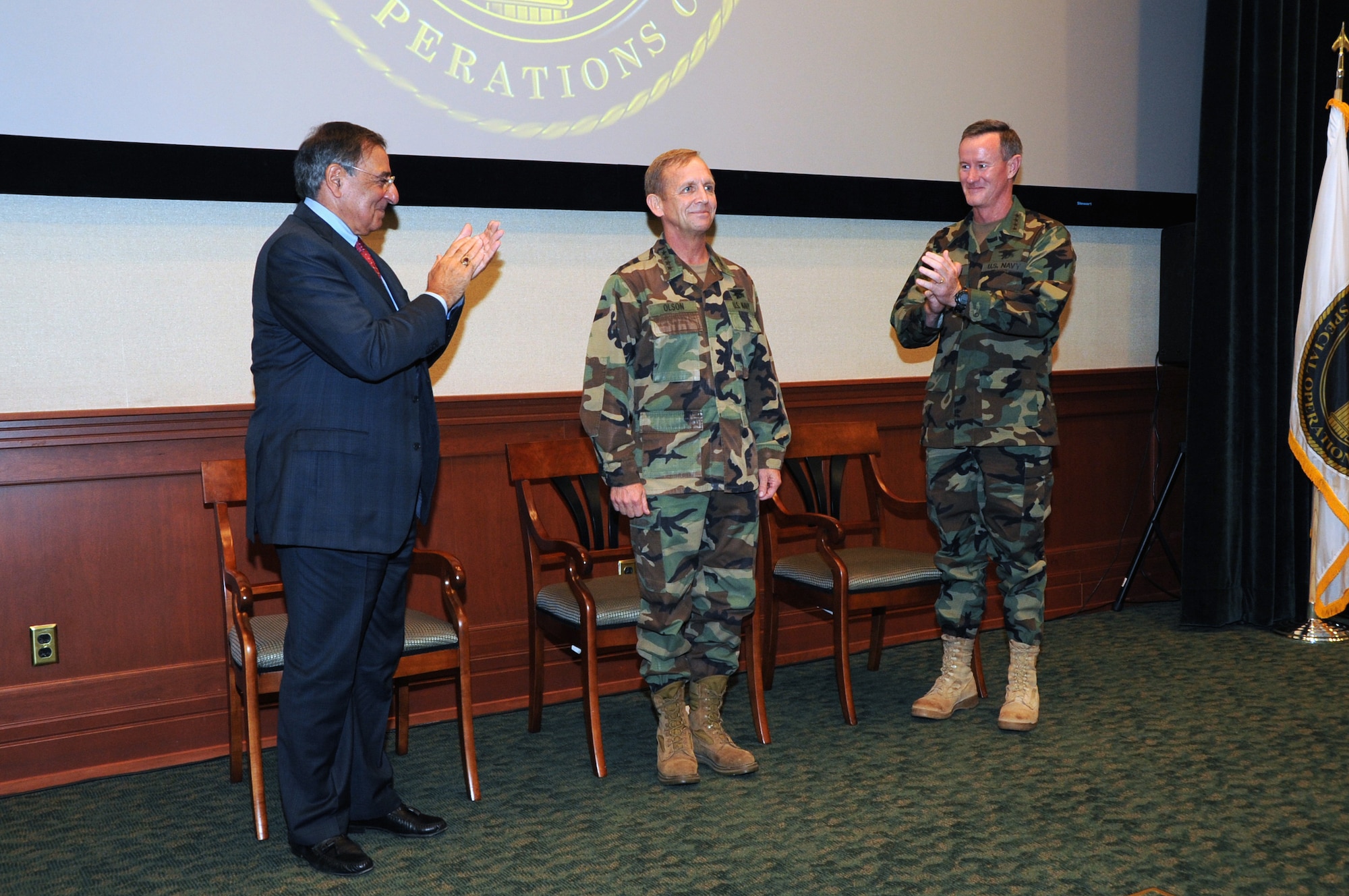 Defense Secretary Leon E. Panetta (left) and Adm. William H. McRaven  applaud Adm. Eric T. Olson during the U.S. Special Operations Command change of command ceremony held at the Davis Conference Center, MacDill Air Force Base, Fla., Aug. 8.  McRaven assumed command and became the ninth commander of USSOCOM. (US Special Operations Command photo by Mike Bottoms)