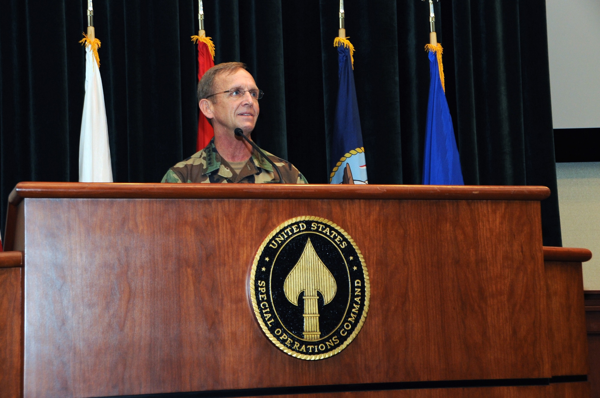 Adm. Eric T. Olson gives remarks during the U.S. Special Operations Command change of command ceremony held at the Davis Conference Center, MacDill Air Force Base, Fla., Aug. 8. Olson was the first Navy SEAL to reach the rank of Admiral and will retire from military service at the end of August. (US Special Operations Command photo by Mike Bottoms)