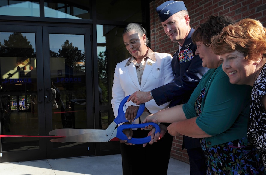 U.S. Air Force Col. Billy Thompson, 23rd Wing commander, along with Sandra Richardson, left, Dawn Coleman and Karen White, far right, cut the ceremonial ribbon during the grand opening ceremony of the Child Development Center II at Moody Air Force Base, Ga., Aug. 15, 2011. Richardson flew out to Moody from the Pentagon to attend the grand opening of the CDC II. (U.S. Air Force photo by Senior Airman Stephanie Mancha/Released)