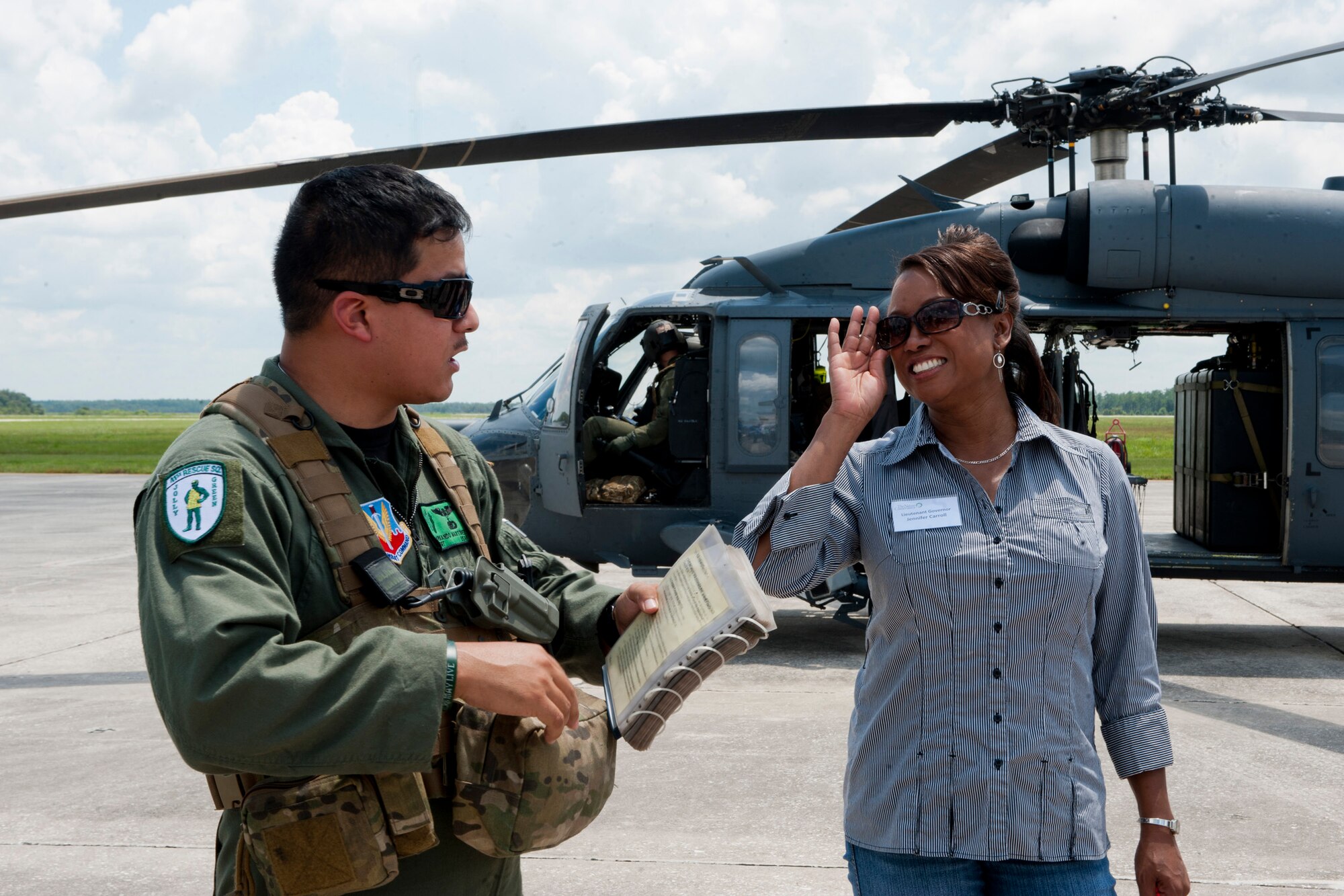 U.S. Air Force Staff Sgt. Armando Martinez, 41st Rescue Squadron, briefs Florida Lt. Gov. Jennifer Carroll prior to boarding an HH-60G Pave Hawk at Avon Park Air Force Range, Fla., Aug. 2, 2011. The governor and other guests saw an aerial view of the 106,000-acre range and areas where developments that may restrict the base’s missions are occurring and where opportunities to buffer APAFR exist. (U.S. Air Force photo by Andrea Thacker/Released)


