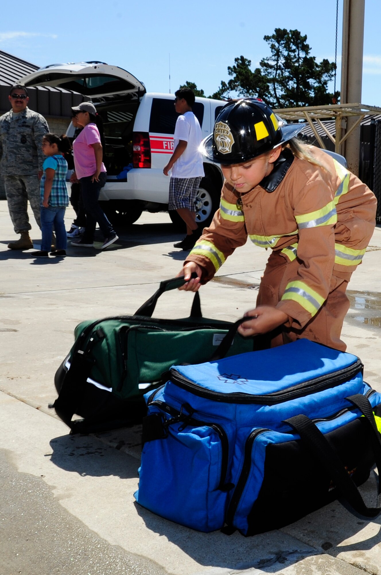 VANDENBERG AIR FORCE BASE, Calif. – Kelli Martin reaches to pick up two bags in the bag run portion of an obstacle course during the Kids Fire Camp at Fire Station 2 here Saturday, Aug. 13, 2011. This event taught some necessary skills to keep children safe in the event of fire. (U.S. Air Force photo/Senior Airman Lael Huss)