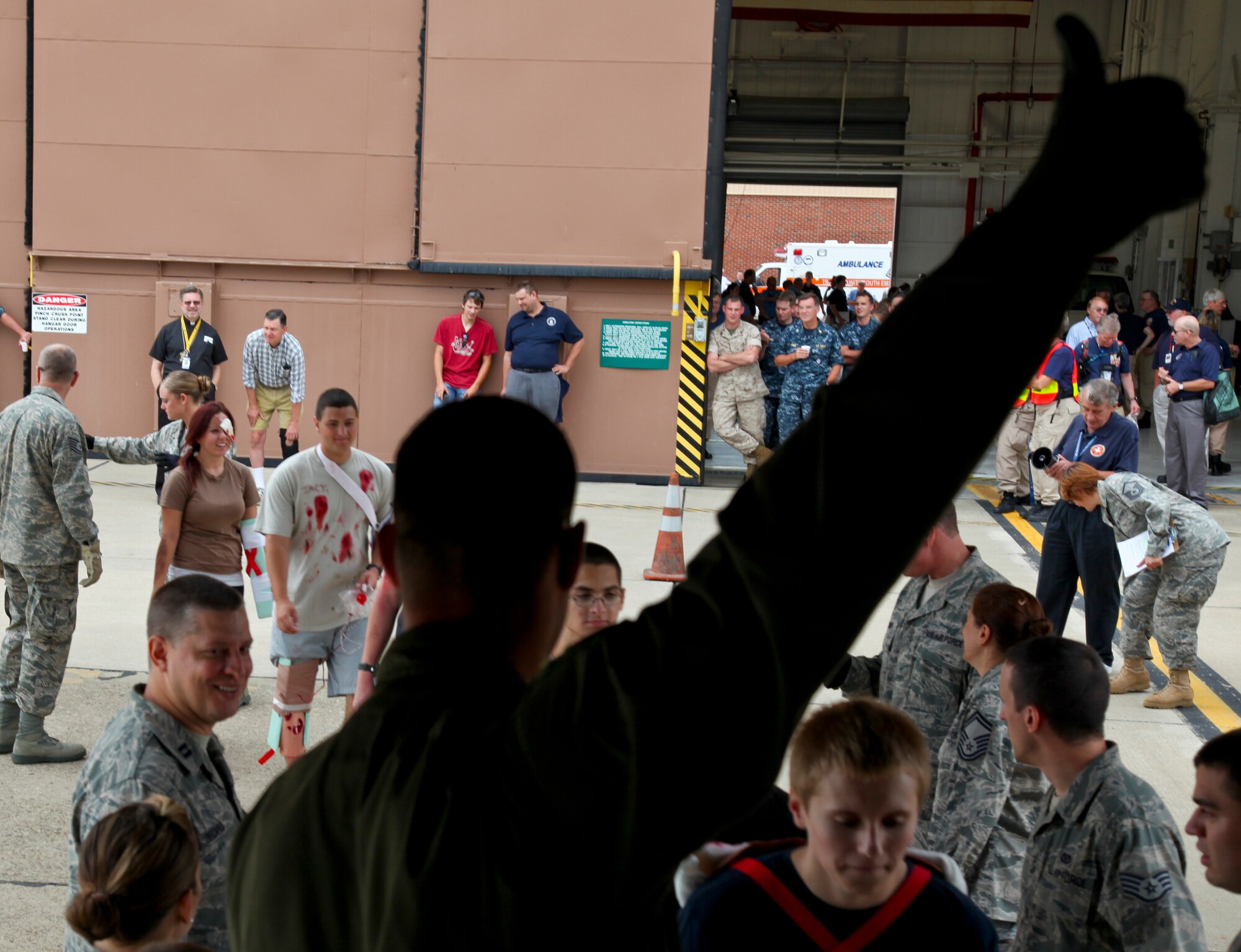 PITTSBURGH IAP ARS, PA -- Capt. Adam Foster, 911th Aeromedical Evacuation Squadron flight nurse, gives a thumbs up signaling for more victims to enter the C-130H during a National Disaster Medical System(NDMS) exercise, Aug. 13. The NDMS serves "national' disasters such as earthquakes, hurricanes, fires, nuclear reactor accidents, weapons of mass destruction events, or an overseas, conventional military conflict producing military casualties evacuated to the Continental United States for treatment. (U.S. Air Force photo/Senior Airman Joshua J. Seybert)