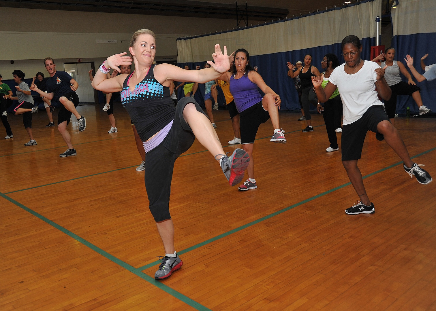 Zumba instructor Leilani Wilson, front, incorporates different music to help her students work up a sweat. (U.S. Air Force photo/Alan Boedeker)