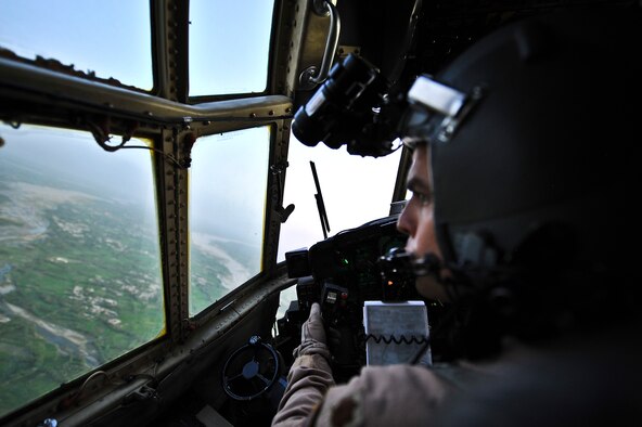 Maj. Stephen Cheek, 746th Expeditionary Airlift Squadron aircraft commander, checks the terrain from the cockpit of a C-130 Hercules during an aeromedical evacuation flight Aug. 7, 2011. Cheek hails from Southern Pines, N.C., and is deployed from Pope Field, N.C. (U.S. Air Force photo/Senior Airman Paul Labbe) 