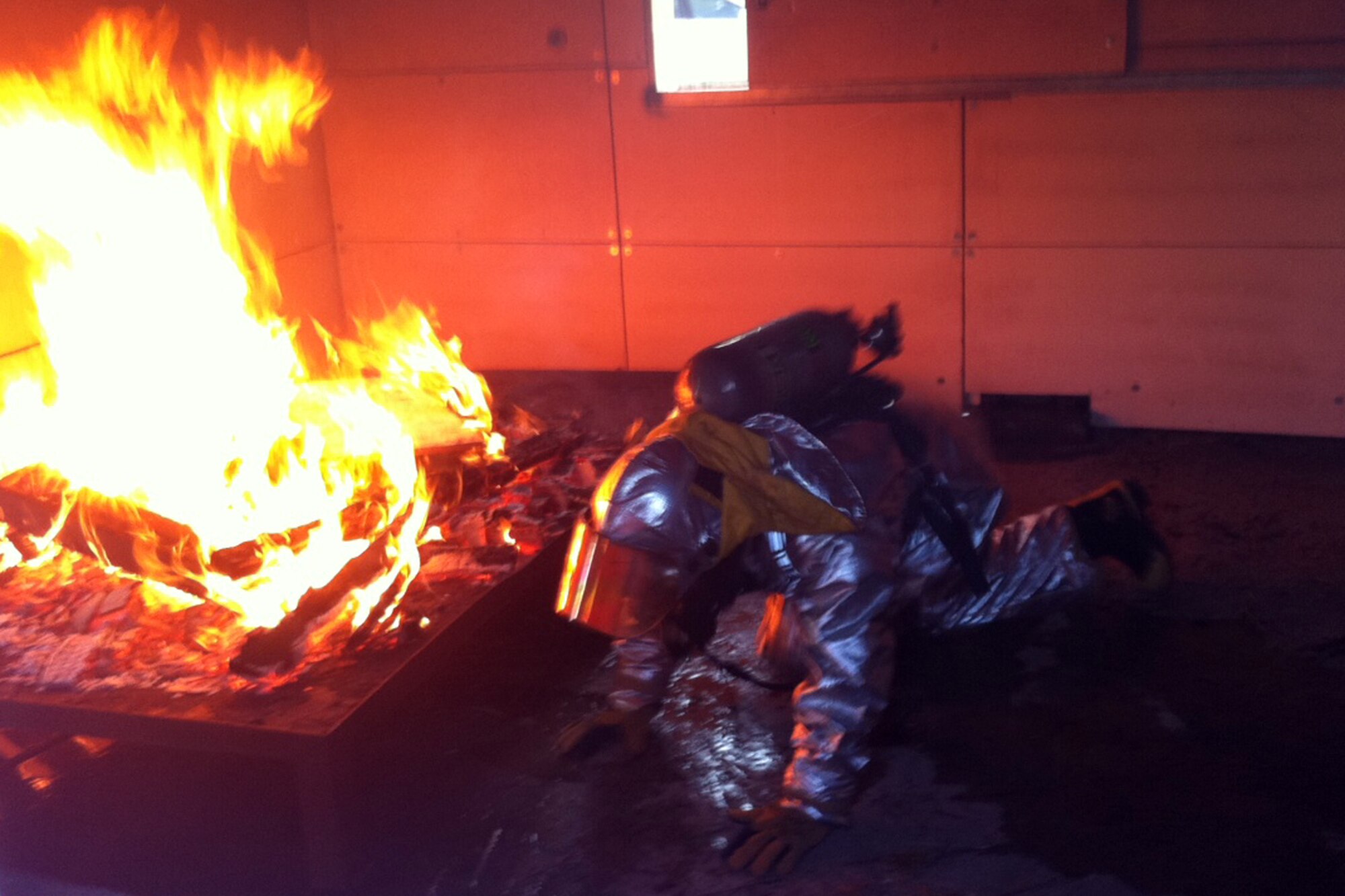 A firefighter from the 307th Civil Engineering Squadron battles a man-made blaze during training at Barksdale Air Force Base, La., Aug. 6, 2011. The firefighters were taking part in live fire structural training. The annual exercise was designed to provide training on putting out commercial and residential fires. (Courtesy photo)