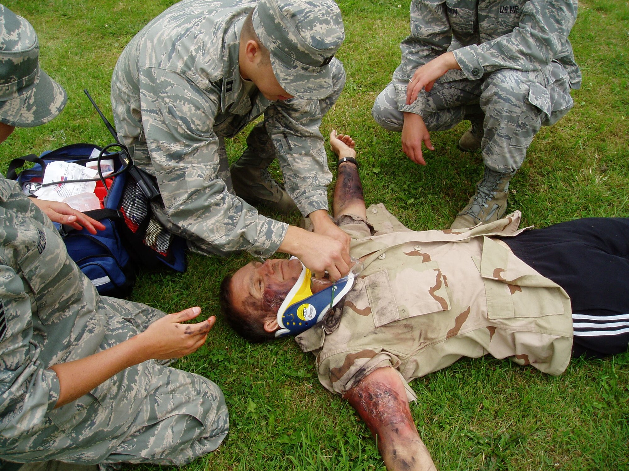 148th Fighter Wing Medical Group members Capt. Aaron Jordan, Staff Sgt. Alex Olson, and Staff Sgt. Amanda Roen attend to a victim during a Mass Casualty Exercise at Spangdahlem Air Base, Germany July 29, 2011.  The 148th deployed more than 30 members to Spangdahlem Air Base for 13 days of hands-on training.