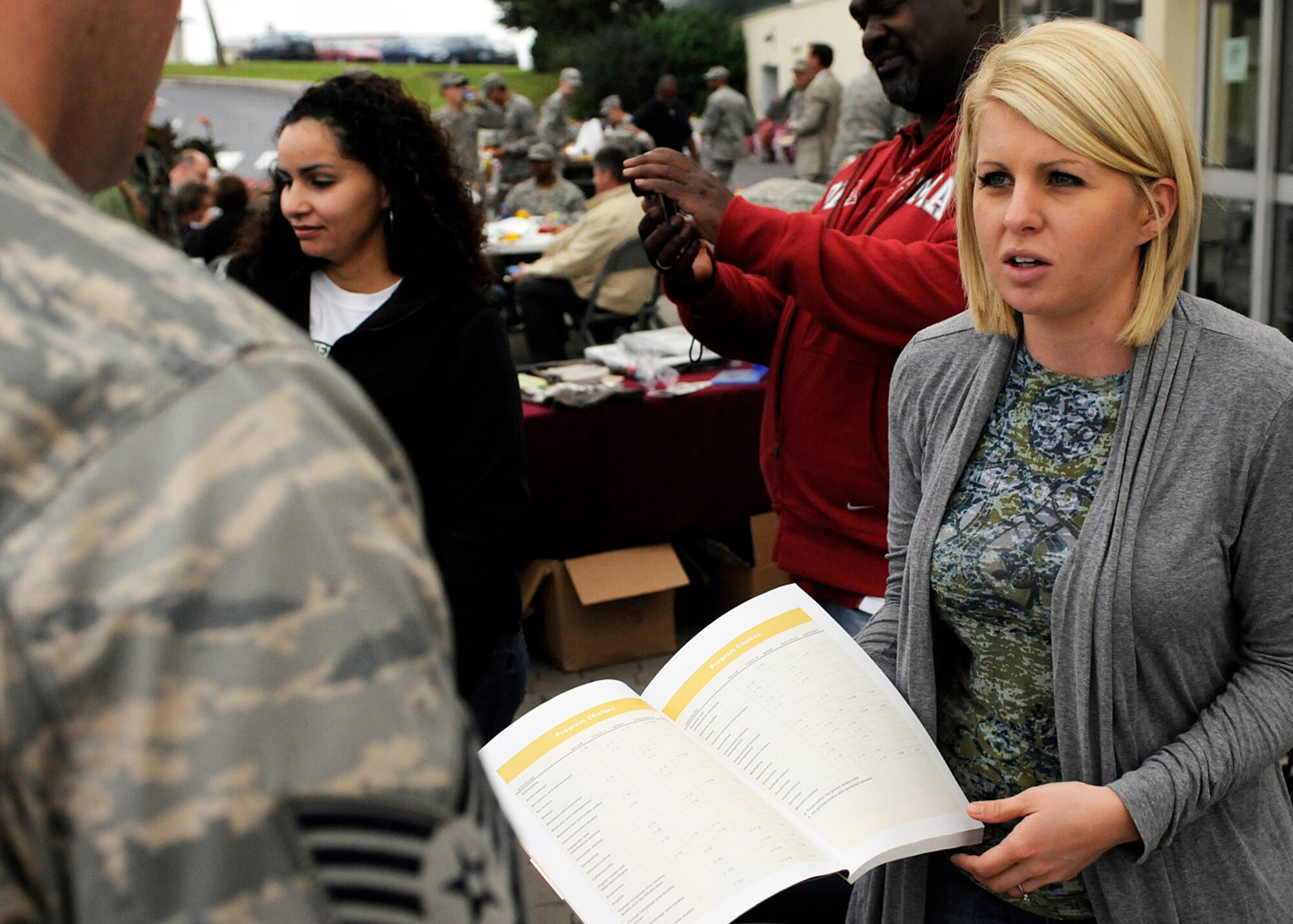 SPANGDAHLEM AIR BASE, Germany -- Staff Sgt. Dmitri Meyer, 52nd Aerospace Medicine Squadron and student, speaks with Megan Portell, University of Maryland University College field representative, during an education fair and cookout in front of the commissary here Aug. 12. More than 200 Airmen participated in the event, which provided information on the upcoming college semester, available classes and general education concerns. (U.S. Air Force photo/Senior Airman Daryl Knee)