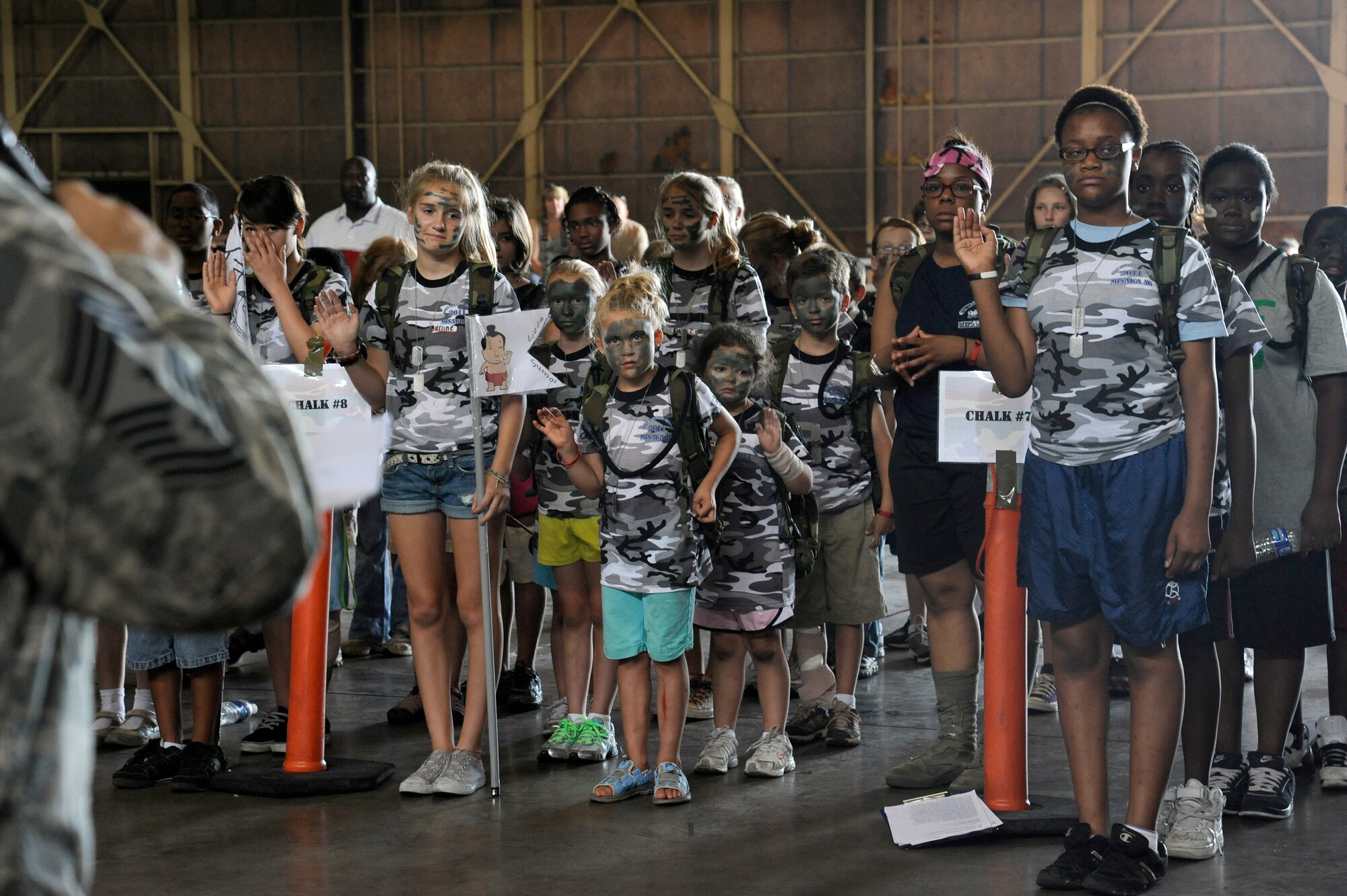 MISAWA AIR BASE, Japan -- Chief Master Sgt. Russell Hastings, left, 35th Fighter Wing, swears in the new recruits during Operation Children on Deployment Exercise Aug. 13.  The children took an oath to have fun and to run their military training leaders around until they could no longer run anymore. (U.S. Air Force photo/Tech. Sgt. Marie Brown)