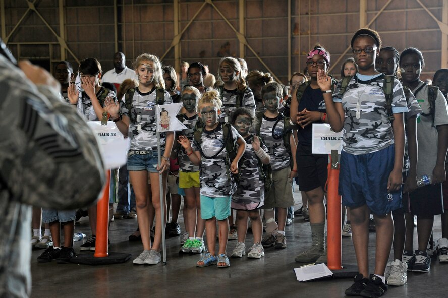 MISAWA AIR BASE, Japan -- Chief Master Sgt. Russell Hastings, left, 35th Fighter Wing, swears in the new recruits during Operation Children on Deployment Exercise Aug. 13.  The children took an oath to have fun and to run their military training leaders around until they could no longer run anymore. (U.S. Air Force photo/Tech. Sgt. Marie Brown)
