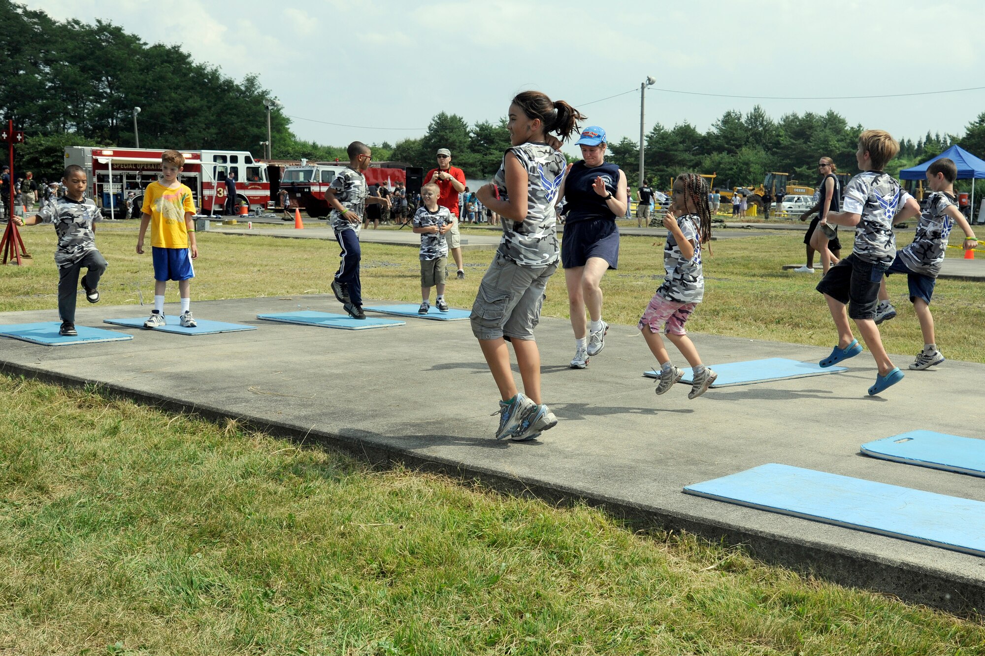 MISAWA AIR BASE, Japan -- Children warm-up for some fitness training during Operation Children on Deployment Exercise Aug. 13. More than 150 children processed through a deployment line and then were bussed to a simulated deployed location for more intensive training, similar to what their parents experience on a normal deployment. (U.S. Air Force photo/Tech. Sgt. Marie Brown)