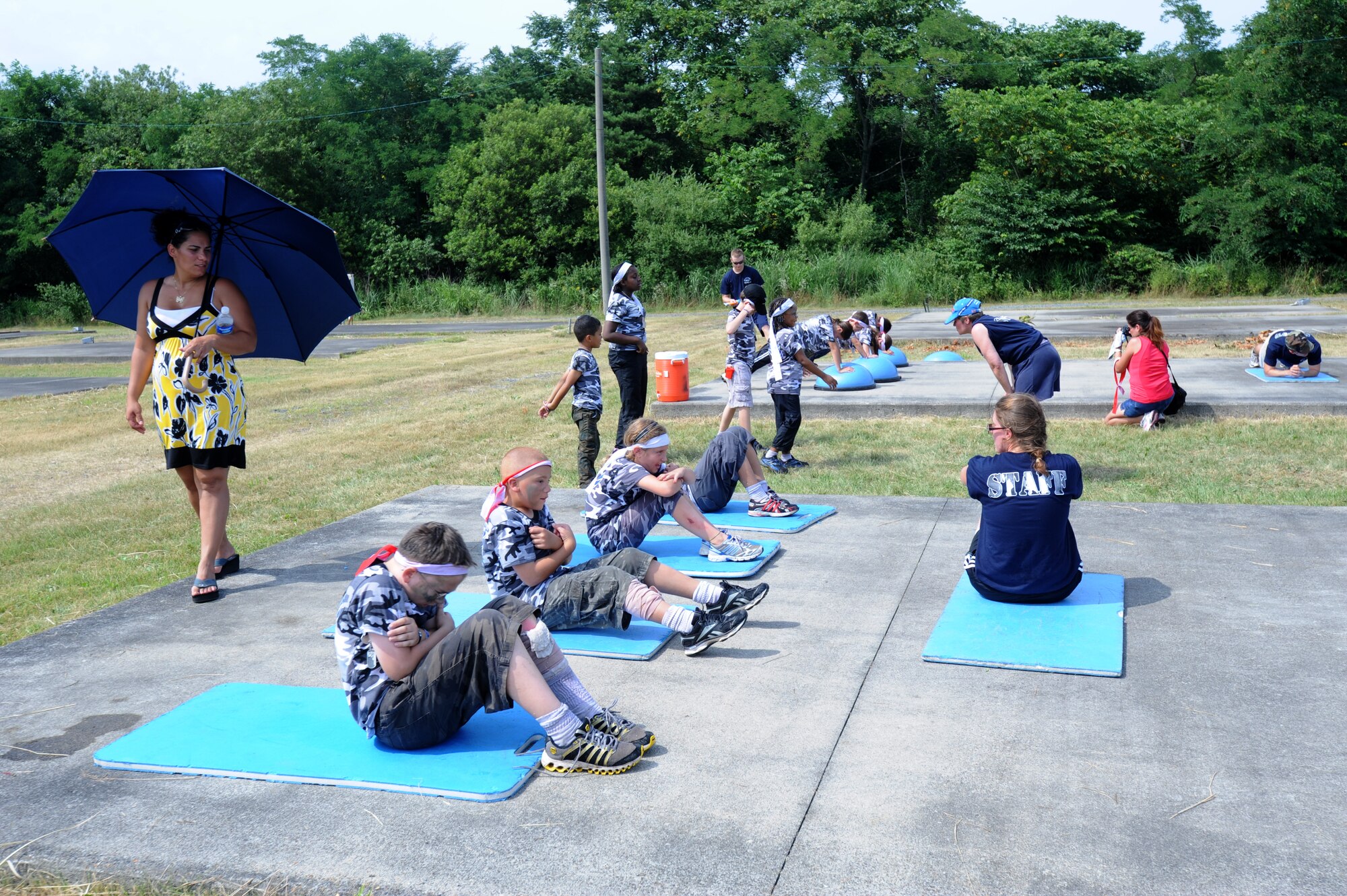 MISAWA Air Base, Japan -- Omaira Garcia, wife of Salvador Garcia, 35th Maintenance Operations Squadron, watches as the kids of Operation Children on Deployment Exercise do core strengthening Aug. 13.  This is the second year Misawa Air Base has held Operation CODE and more than 150 children of the base participated.  (U.S. Air Force photo/Staff Sgt. April Quintanilla)