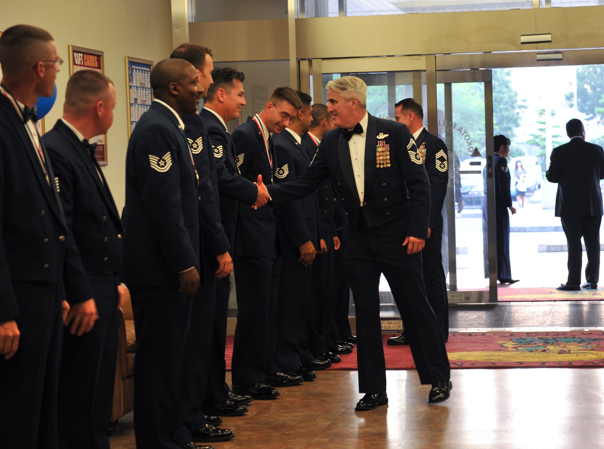 YOKOTA AIR BASE, Japan -- Inductees greet guests attending the Senior Non-Commissioned  Induction Ceremony at Yokota Air Base, Japan, Aug. 11, 2011. The ceremony formally recognizes Airmen in the transition from the NCO to the senior NCO tier. (U.S. Air Force photo/Senior Airman Andrea Salazar)