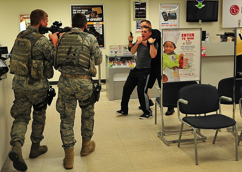 Day four and five of the QRT training, August 12-13, rigorous physical training continued as obstacles increased with difficulty testing not only their strength but also their capabilities to act as a cohesive squad. Day four, SF Airmen were taught how to respond to an active shooter and/or hostage scenario in the Base Exchange and the base dormitories, as well as extraction of an active shooter in a vehicle. Day five SF Airmen performed combative training and practical exercises. Physical training sessions were themed in memory of the 31 warriors lost in Afghanistan, August 7, 2011, by each volunteer completing 31 of each exercise throughout the course. A QRT member provides immediate response to any high risk situation on Osan Air Base to include barricaded suspects, workplace violence, domestic violence and abuse response, school violence, and disaster response. (Photo by Staff Sgt. Daylena Gonzalez)  