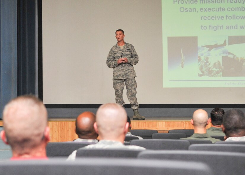 Col. Patrick McKenzie, 51st Fighter Wing commander, speaks with Airmen, family members and civilians during an hour-long Town Hall meeting held at the base theater, Aug. 10. The commander updated Osan citizens on several infrastructure projects and upcoming events before taking questions asked by attendees or submitted via e-mail. (U.S. Air Force Photos by/ Senior Airman Adam Grant)