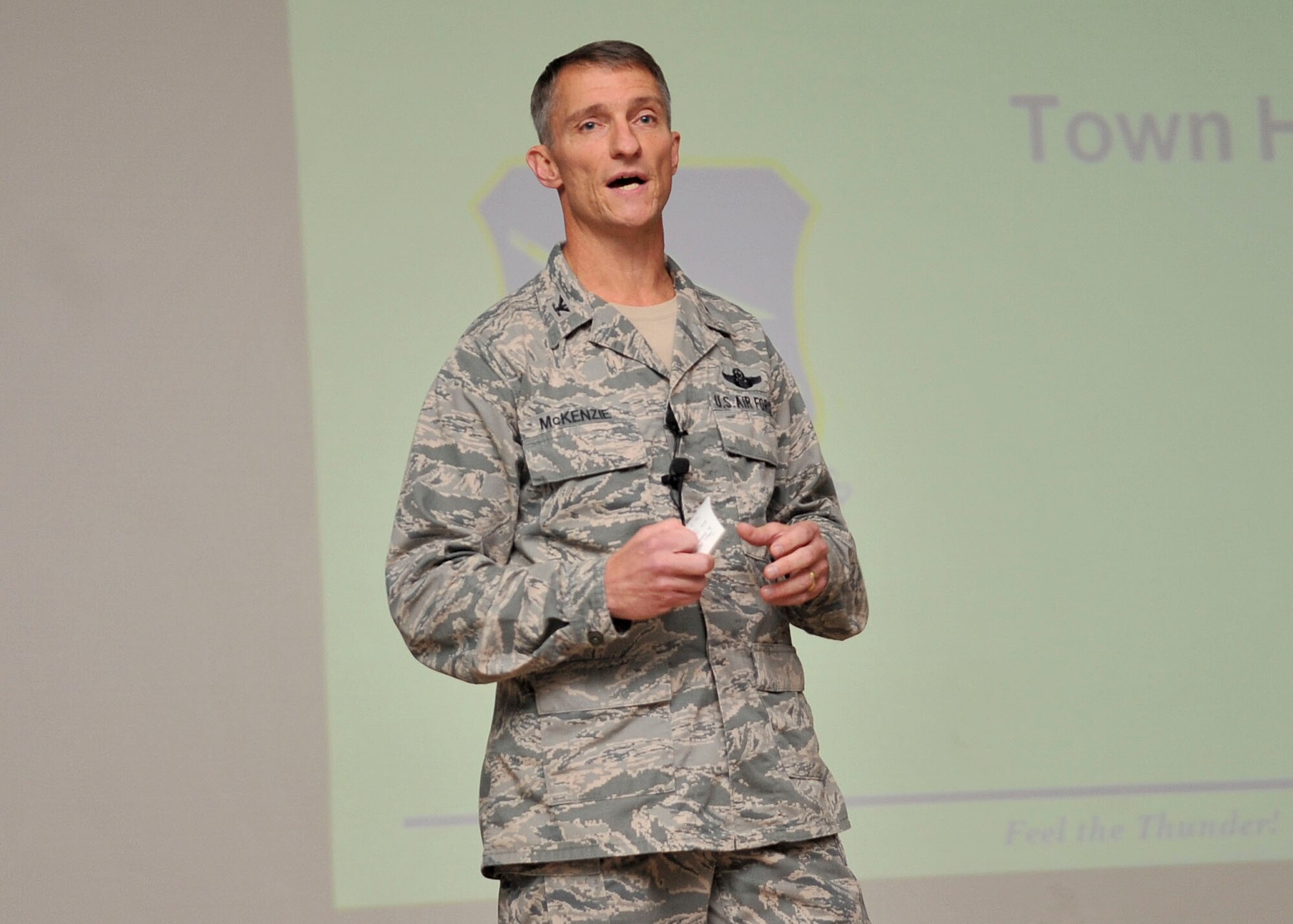 Col. Patrick McKenzie, 51st Fighter Wing commander, speaks with Airmen and family members during a Town Hall meeting, Aug. 10. During the meeting the commander informed members of team Osan and their families of several infrastructure projects and upcoming events before opening the floor to questions. (U.S. Air Force Photos by/ Senior Airman Adam Grant)