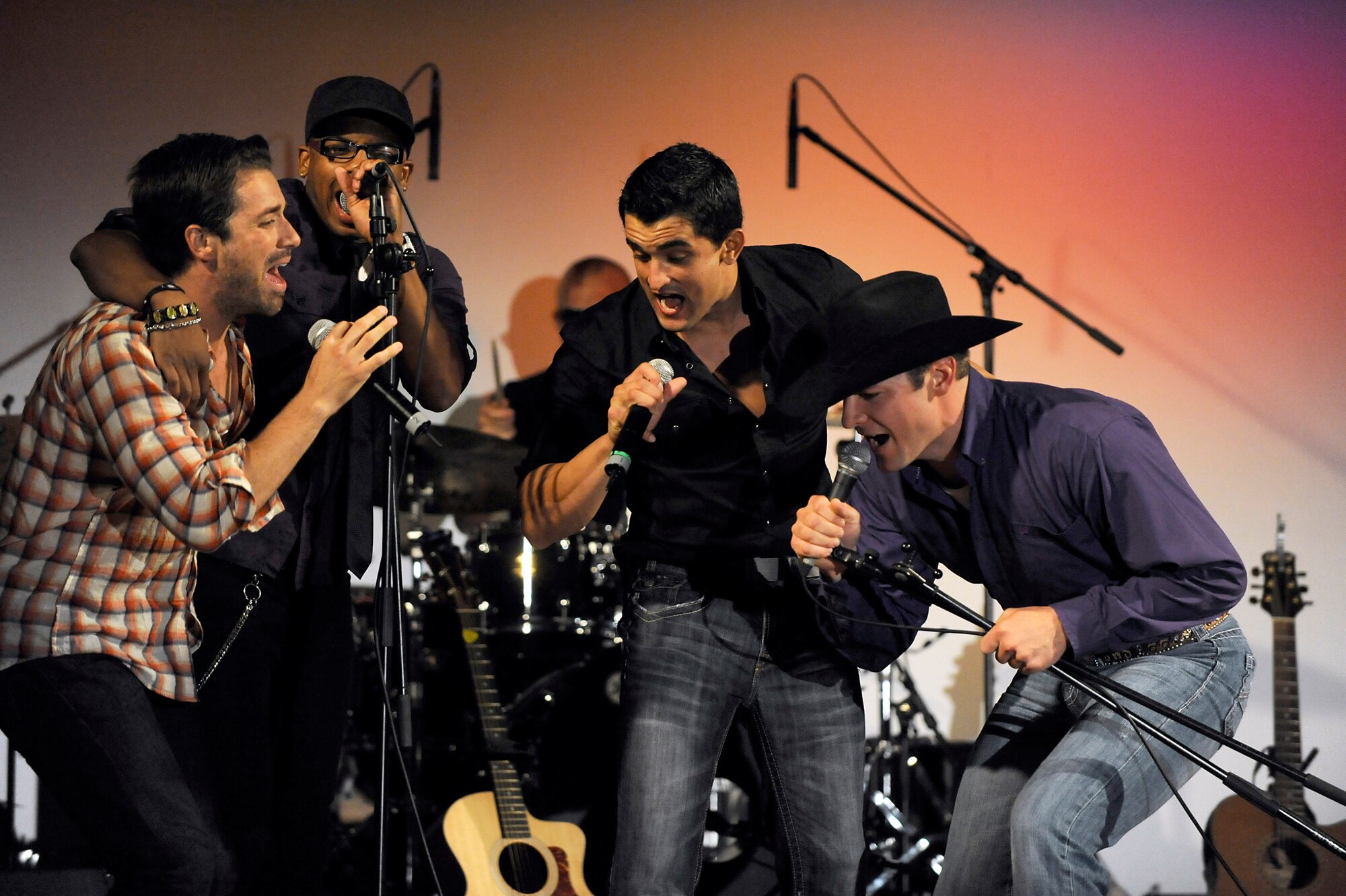 MISAWA AIR BASE, Japan -- The men of American Idol sing together during a live concert at the Richard Bong Training Facility Aug. 12. Members of American Idol visited Misawa as part of an Armed Forces Entertainment show to support military members and their families. (U.S. Air Force photo/Tech. Sgt. Marie Brown)