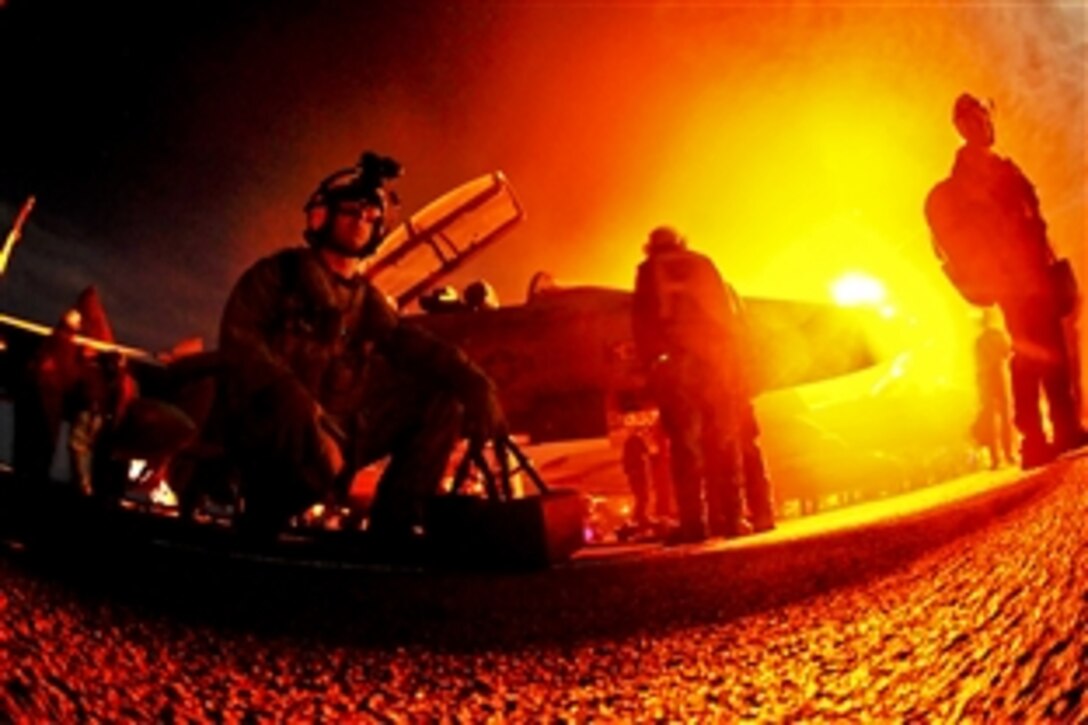 U.S. Navy Petty Officer 1st Class Andrew Reischauer waits to board an MH-60S Seahawk helicopter between flight cycles aboard the aircraft carrier USS John C. Stennis in the Pacific Ocean, Aug. 11, 2011. The John C. Stennis Carrier Strike Group is deployed to the western Pacific Ocean and Arabian Gulf.